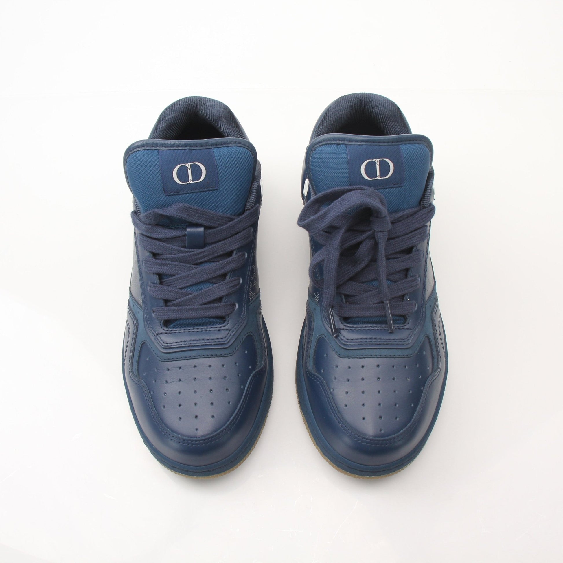 Christian Dior Navy Oblique sneakers with white soles and gold accents, featuring the signature Dior pattern and stylish laces.