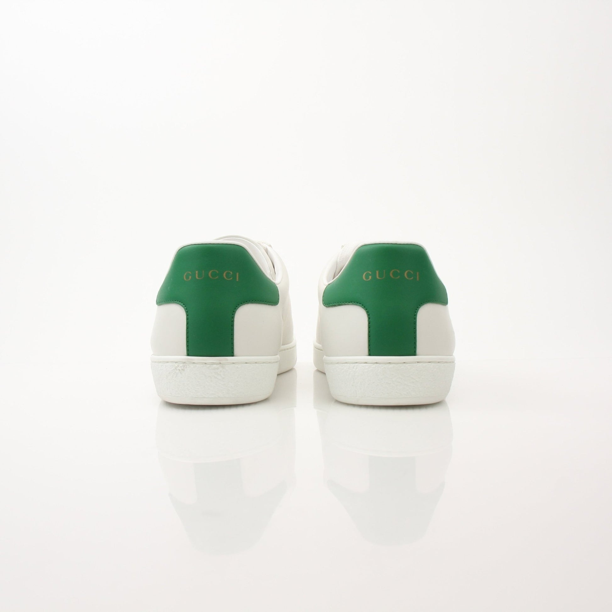 Gucci Women’s Ace Kitten Logo Sneakers in white with black accents, featuring signature Gucci logo on the side.