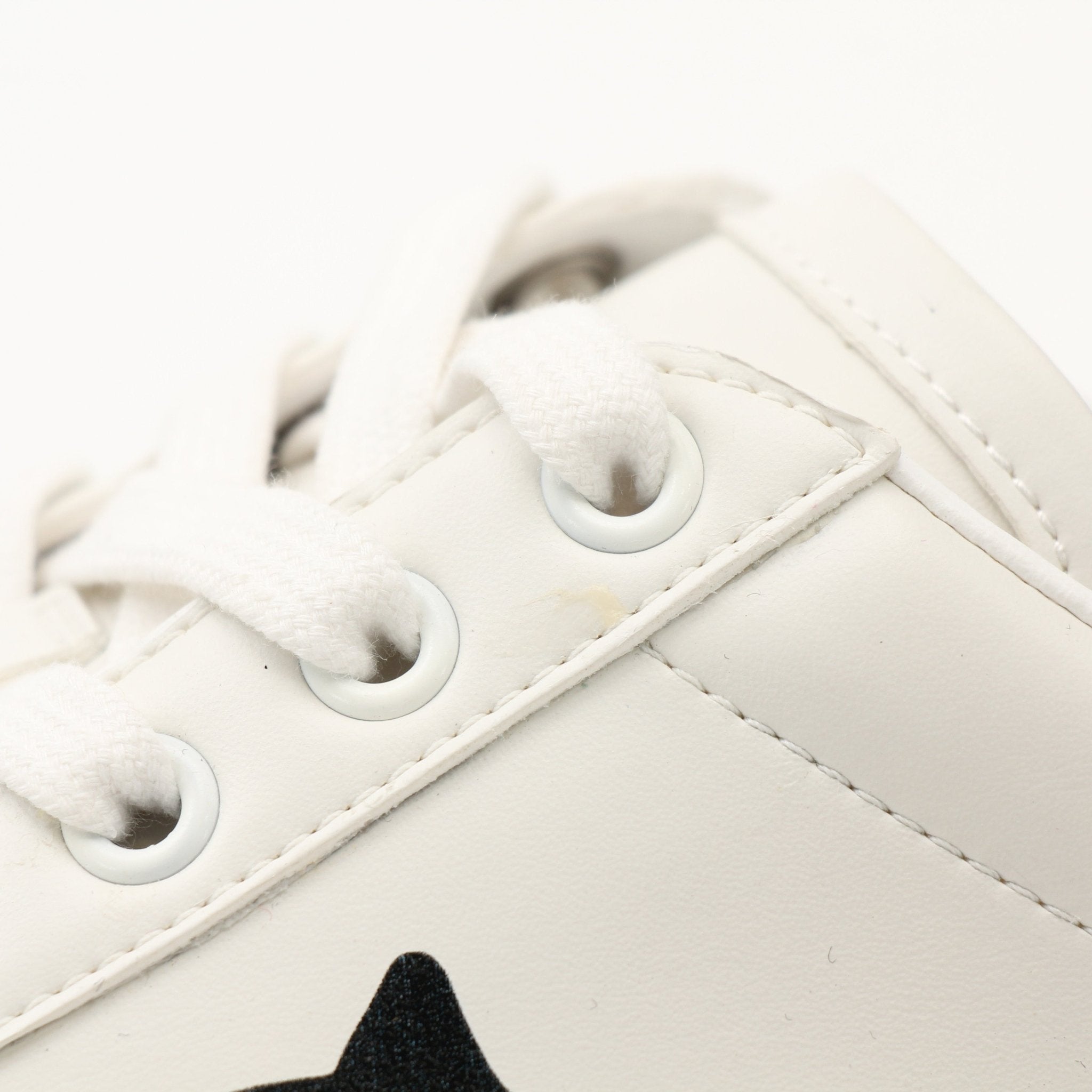 Gold & Beyond Gucci women’s Ace kitten logo sneakers with white leather and signature green and red stripe details.