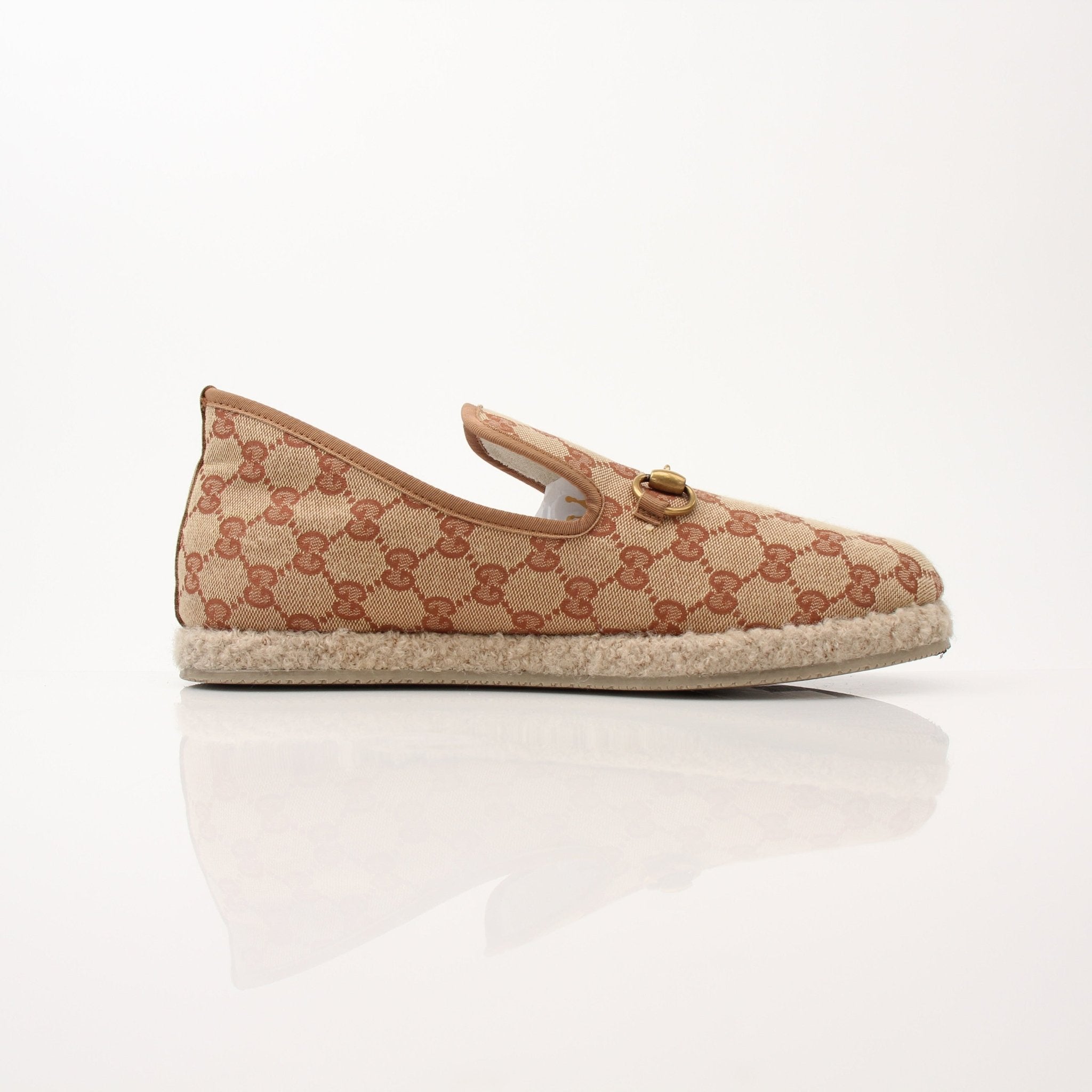 Gold & Beyond Gucci men’s GG Fria loafers, stylish leather shoes with signature logo, displayed on a neutral background.