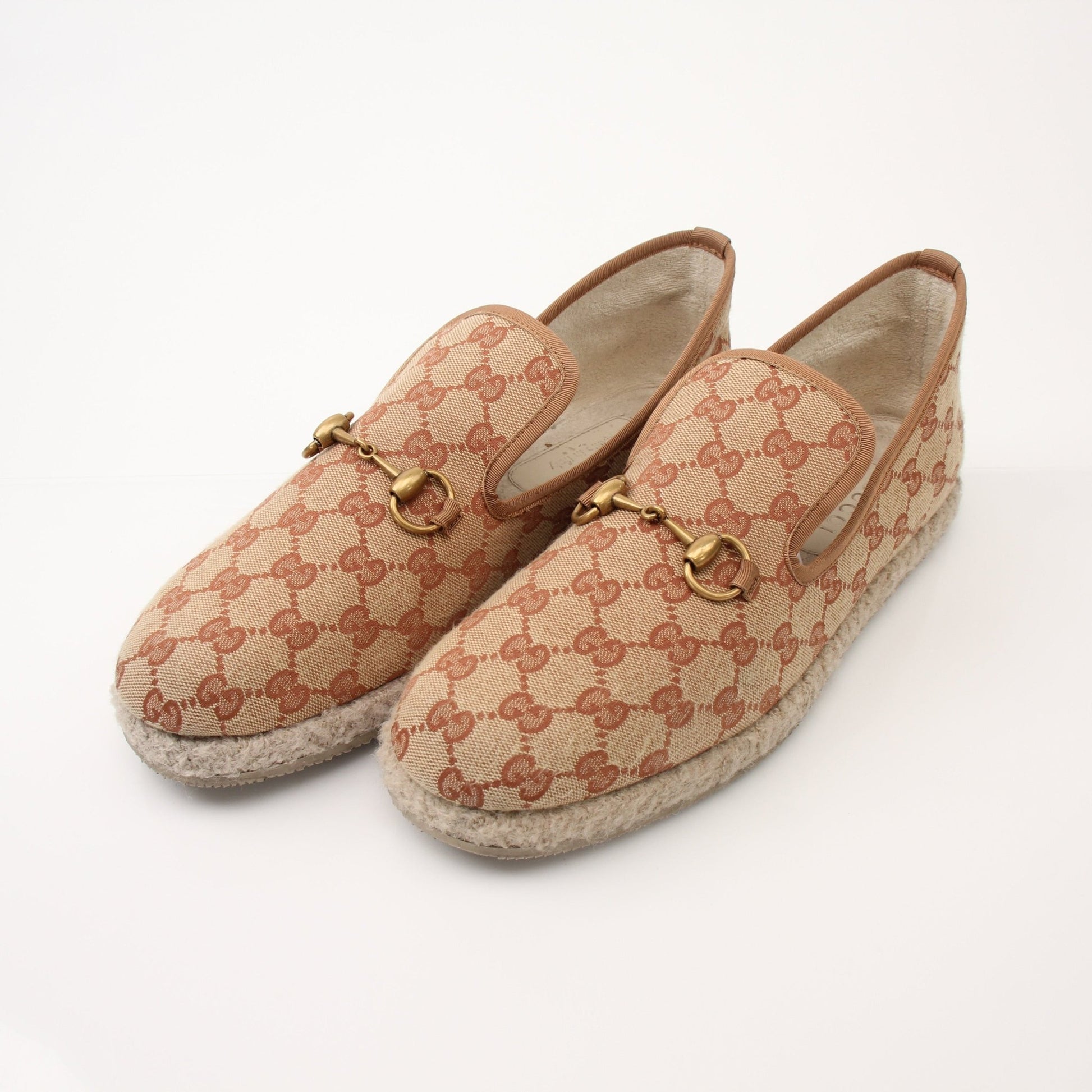 Gold & Beyond men's Gucci GG Fria loafers, stylish leather shoes with iconic logo details, shown on a neutral background.