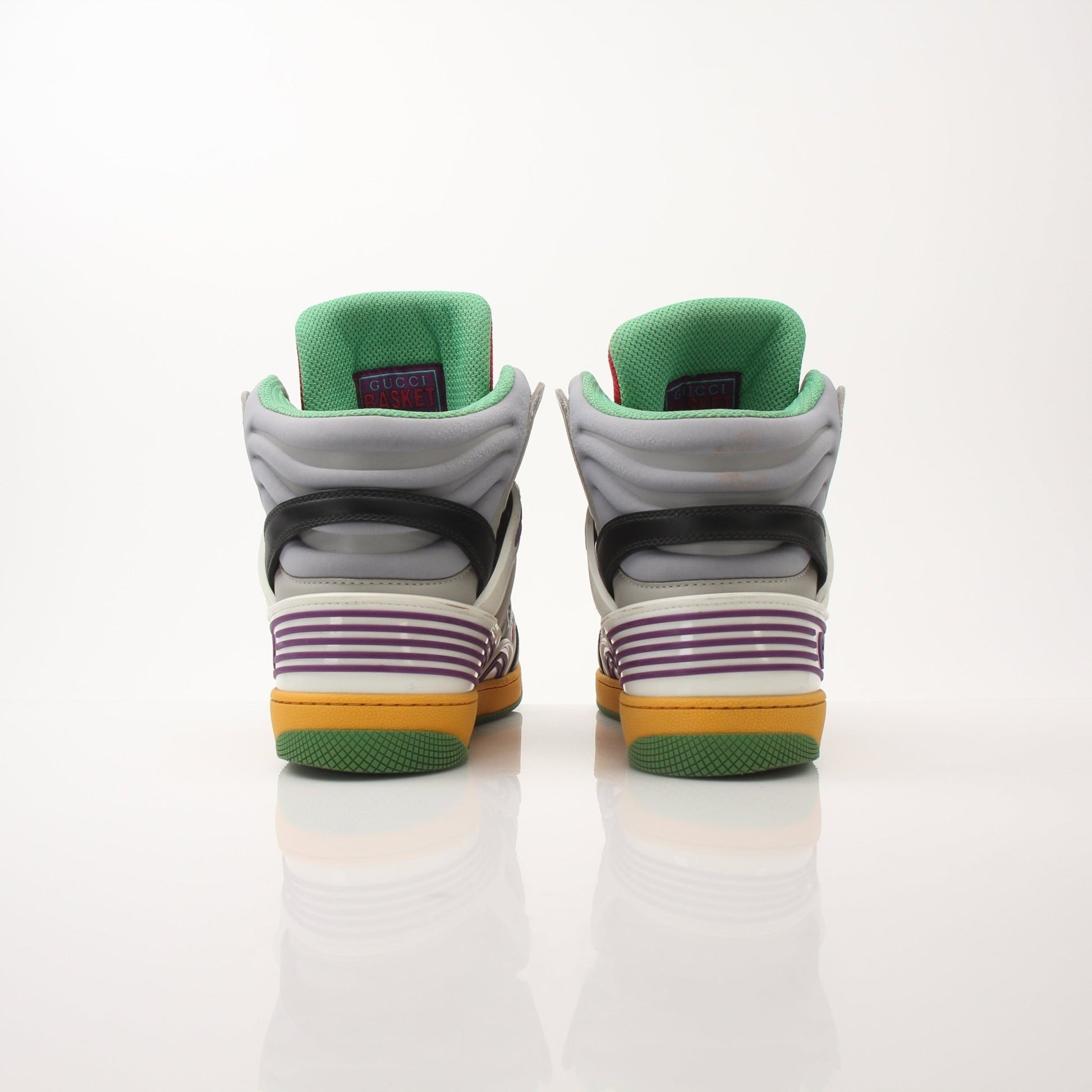 Gold & Beyond Gucci men's high-top basketball sneakers with black leather and signature design, displayed from a side angle.