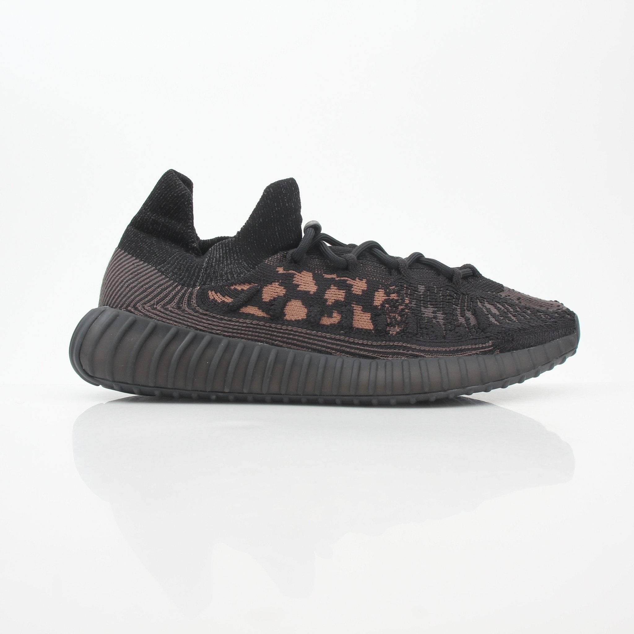 Black Adidas Yeezy Boost 350 V2 CMPCT sneakers with low-top design and textured fabric, displayed on a white background.