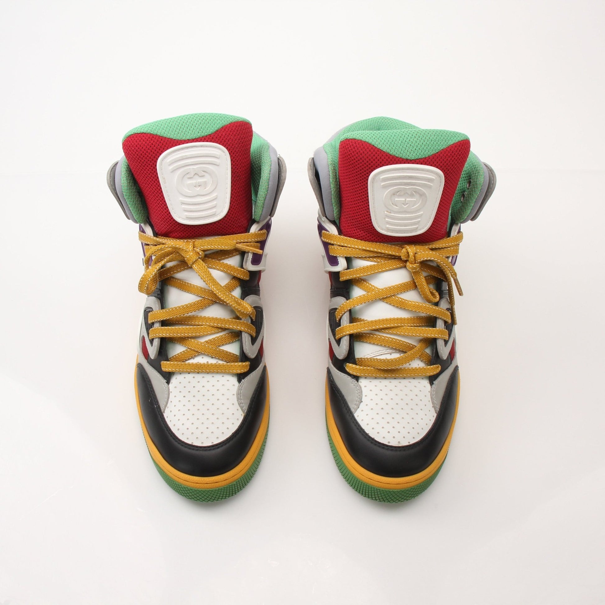 Gucci men's high top basketball sneakers in black with white accents, featuring a stylish design and logo details.