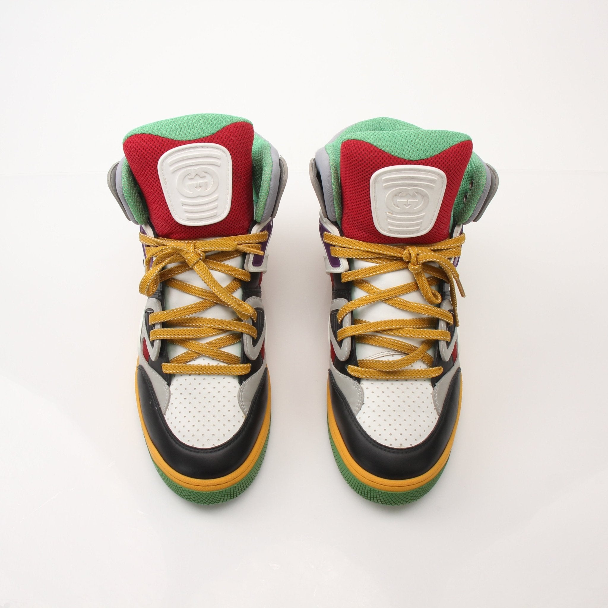 Gucci men's high top basketball sneakers in black with white accents, featuring a stylish design and logo details.