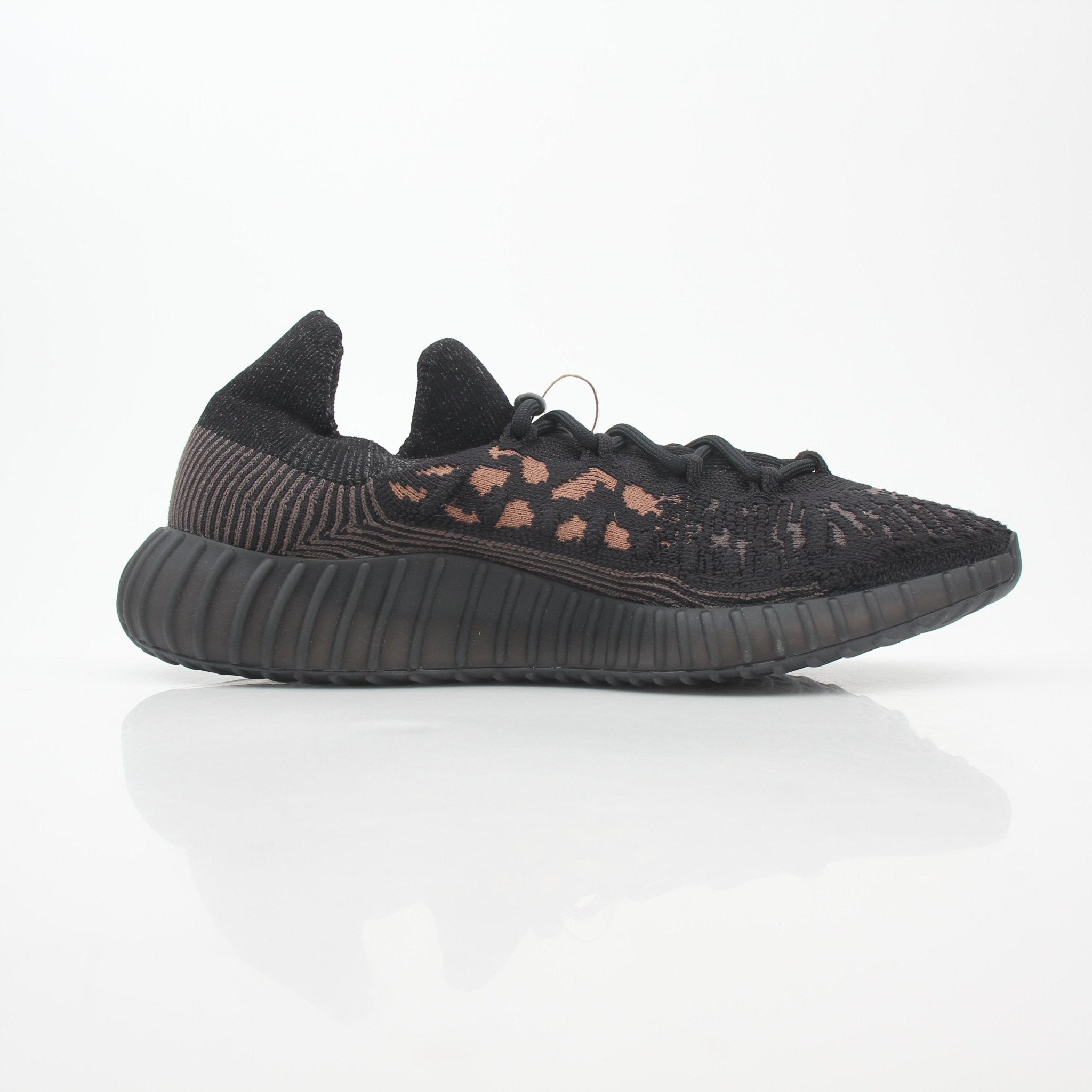 Black Adidas Yeezy Boost 350 V2 CMPCT low-top sneakers with sleek design and Adidas branding, displayed on a white background.