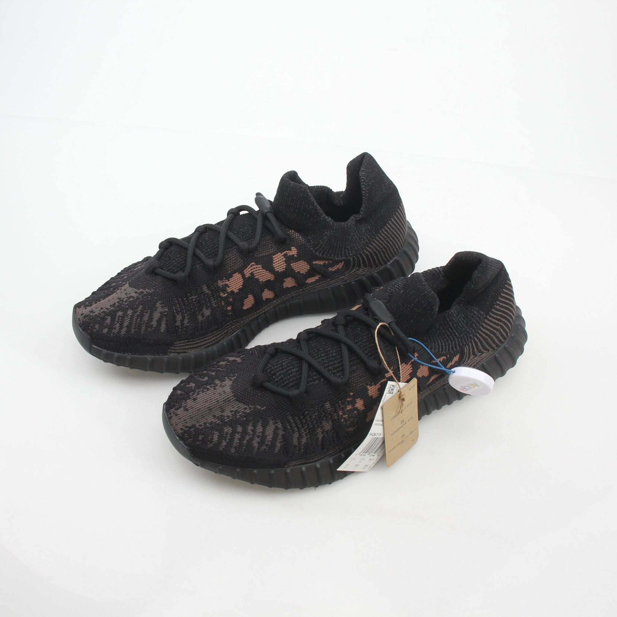 Black Adidas Yeezy Boost 350 V2 CMPCT low-top sneakers with Primeknit upper and Boost sole, displayed on a white background.
