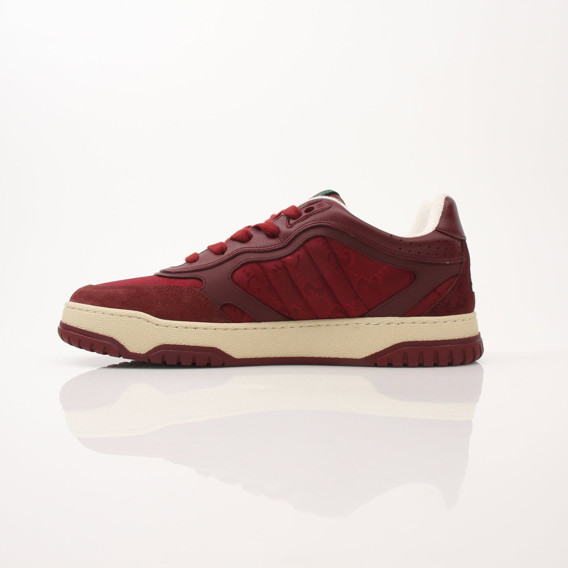 Gucci Men’s Re-Web Sneakers showing white and green canvas shoes with red stripe detail and white sole, displayed on a plain background.
