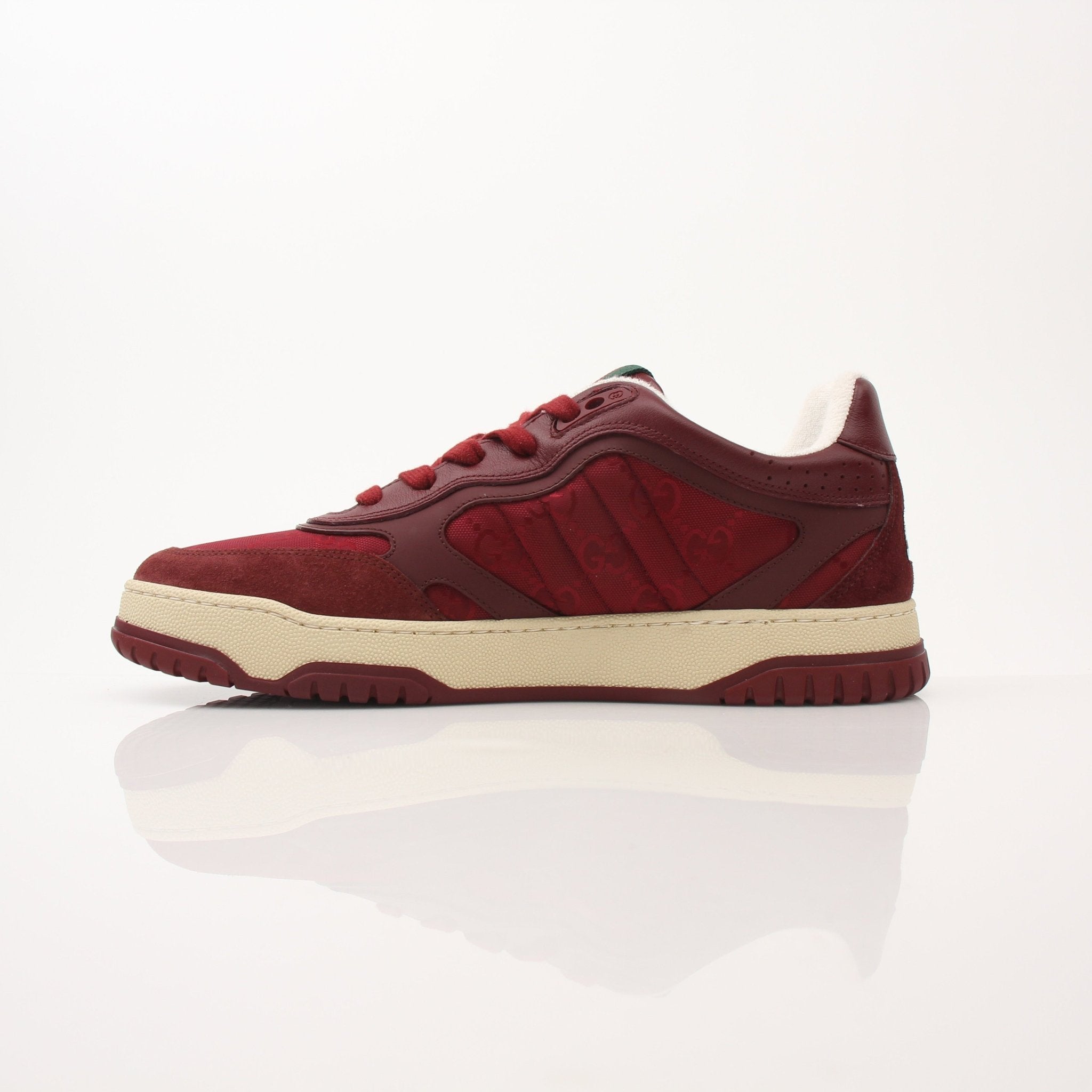 Gucci Men’s Re-Web Sneakers showing white and green canvas shoes with red stripe detail and white sole, displayed on a plain background.