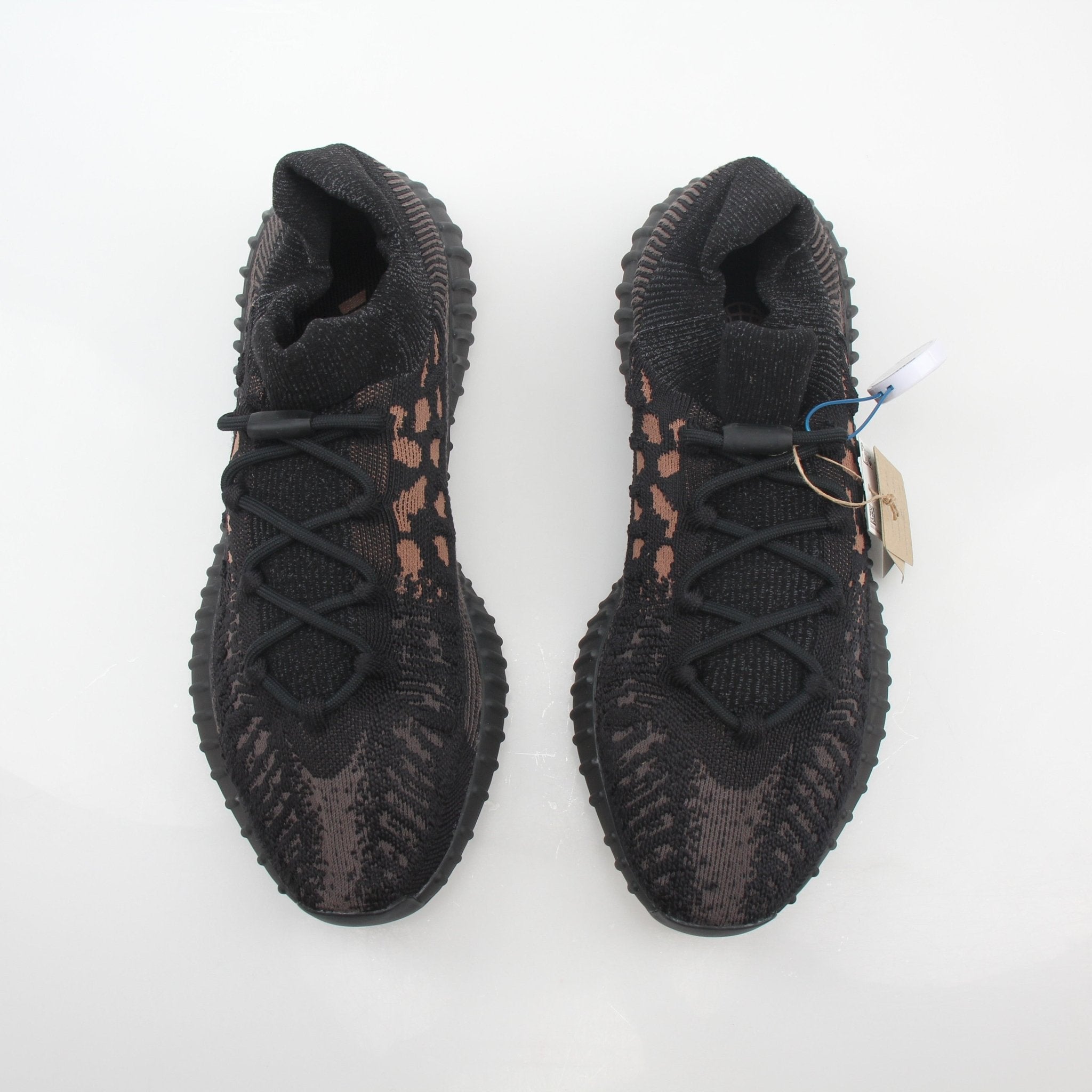 Black Adidas Yeezy Boost 350 V2 CMPCT low-top sneakers by Gold & Beyond, showing the sleek design and textured upper.