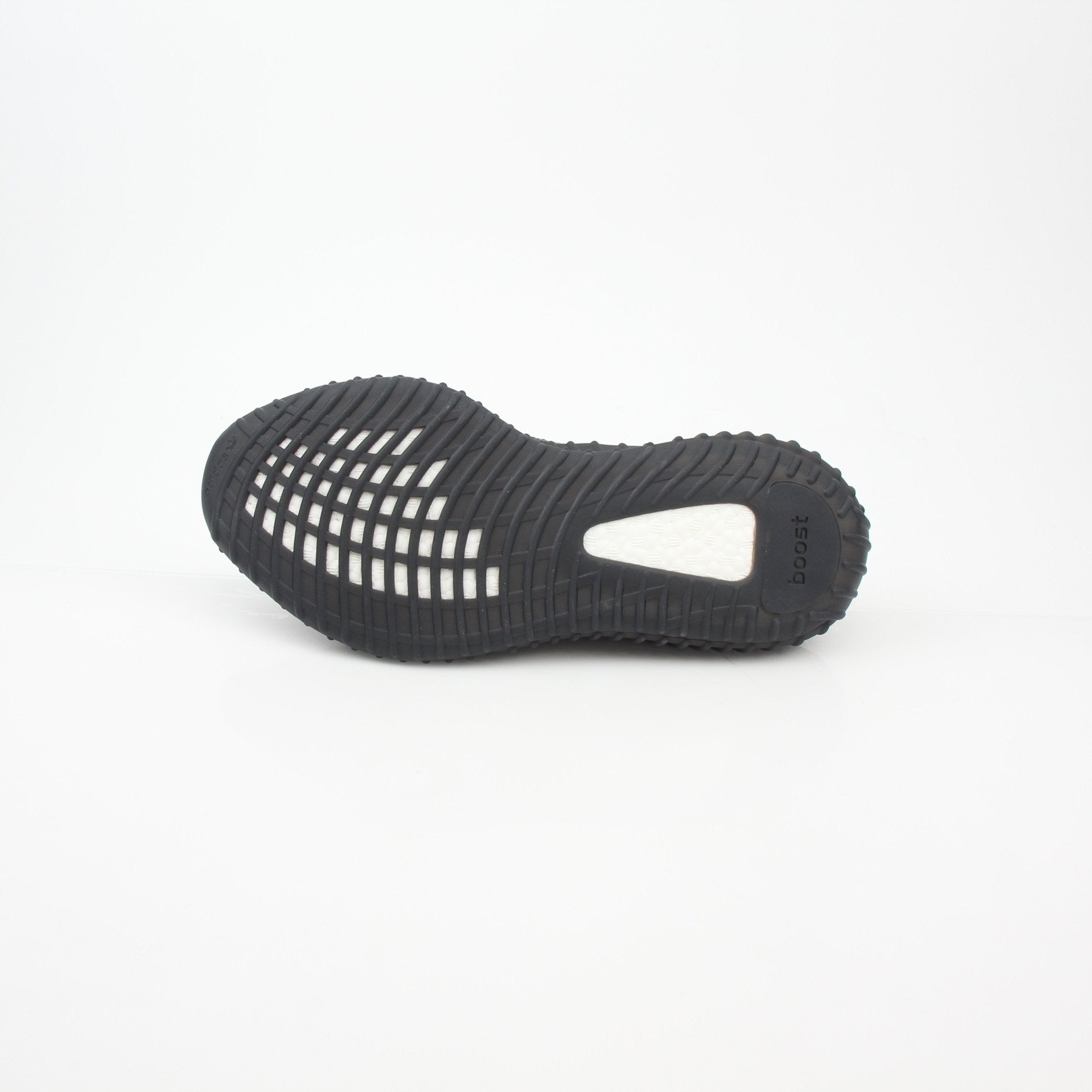 Black Adidas Yeezy Boost 350 V2 CMPCT low-top sneakers with sleek design and signature Boost sole, displayed on a plain background.
