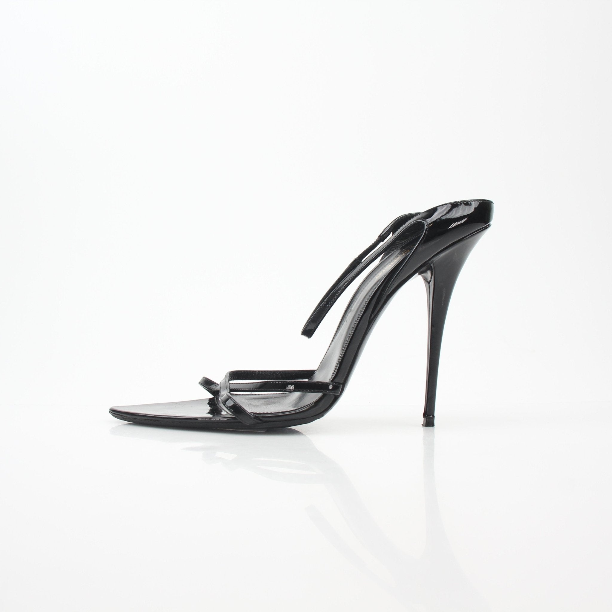 Black Saint Laurent Gippy pointed sandals with stiletto heels and gold accents, stylishly displayed on a neutral background.