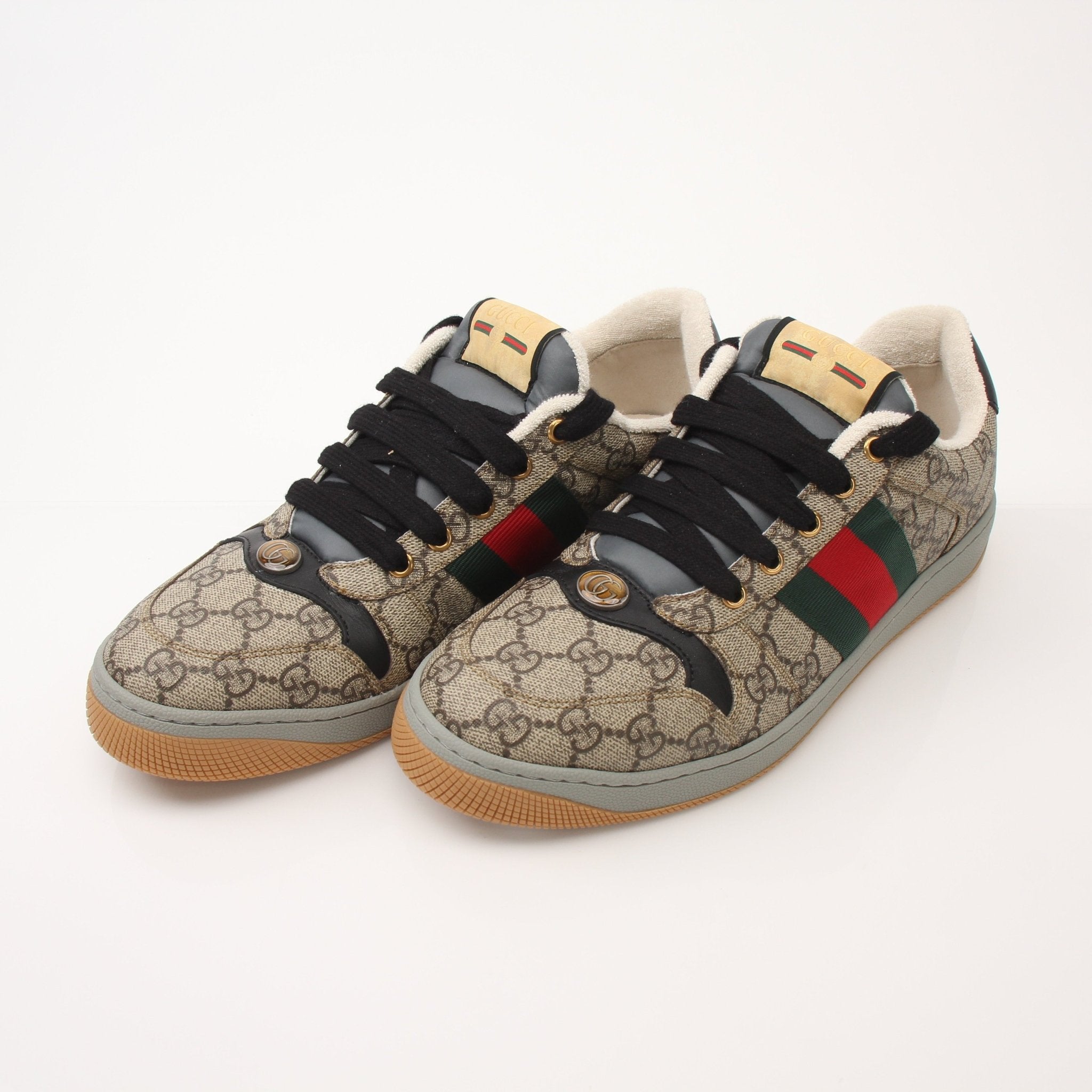 Gold & Beyond Gucci Men’s Screener GG sneakers, stylish casual shoes with signature GG pattern and white soles.