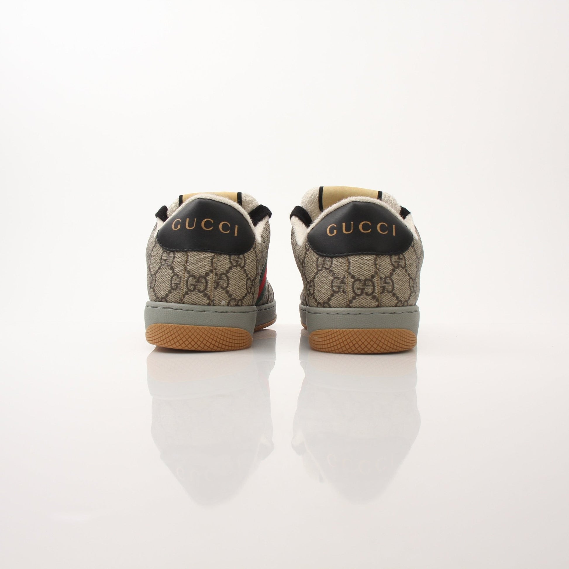Gold & Beyond Gucci Men’s Screener GG Sneakers, stylish sneakers with signature GG pattern and casual design, shown in side view.