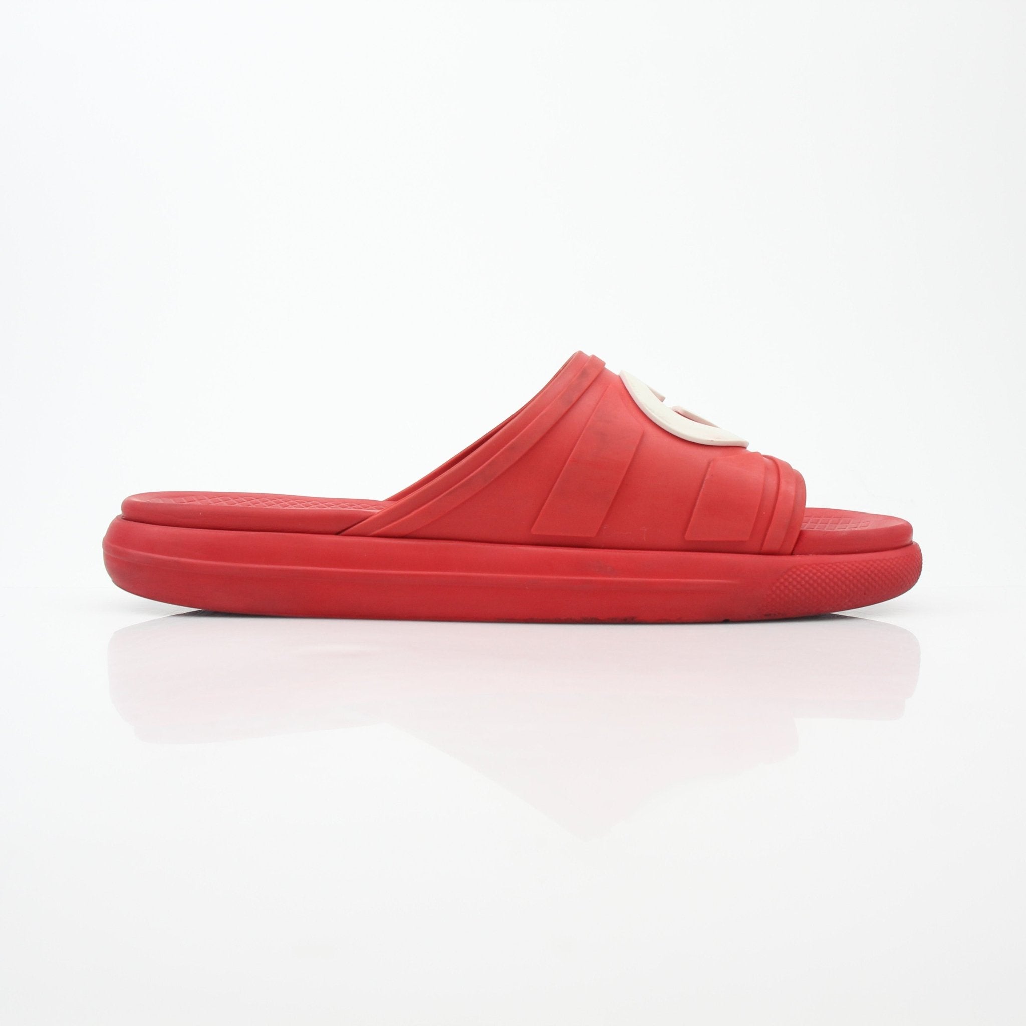 Gucci red interlocking G slide sandals featuring open-toe design and comfortable slip-on style.