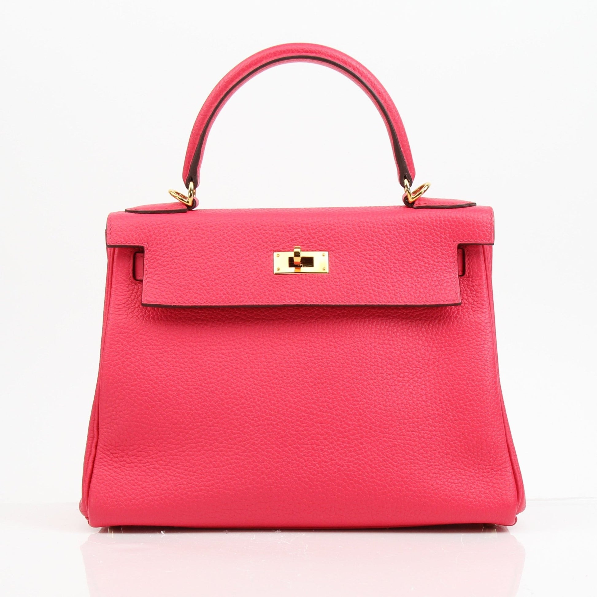 Hermès Kelly 28 pink Togo leather handbag with gold hardware, showcasing a structured design and top handle.