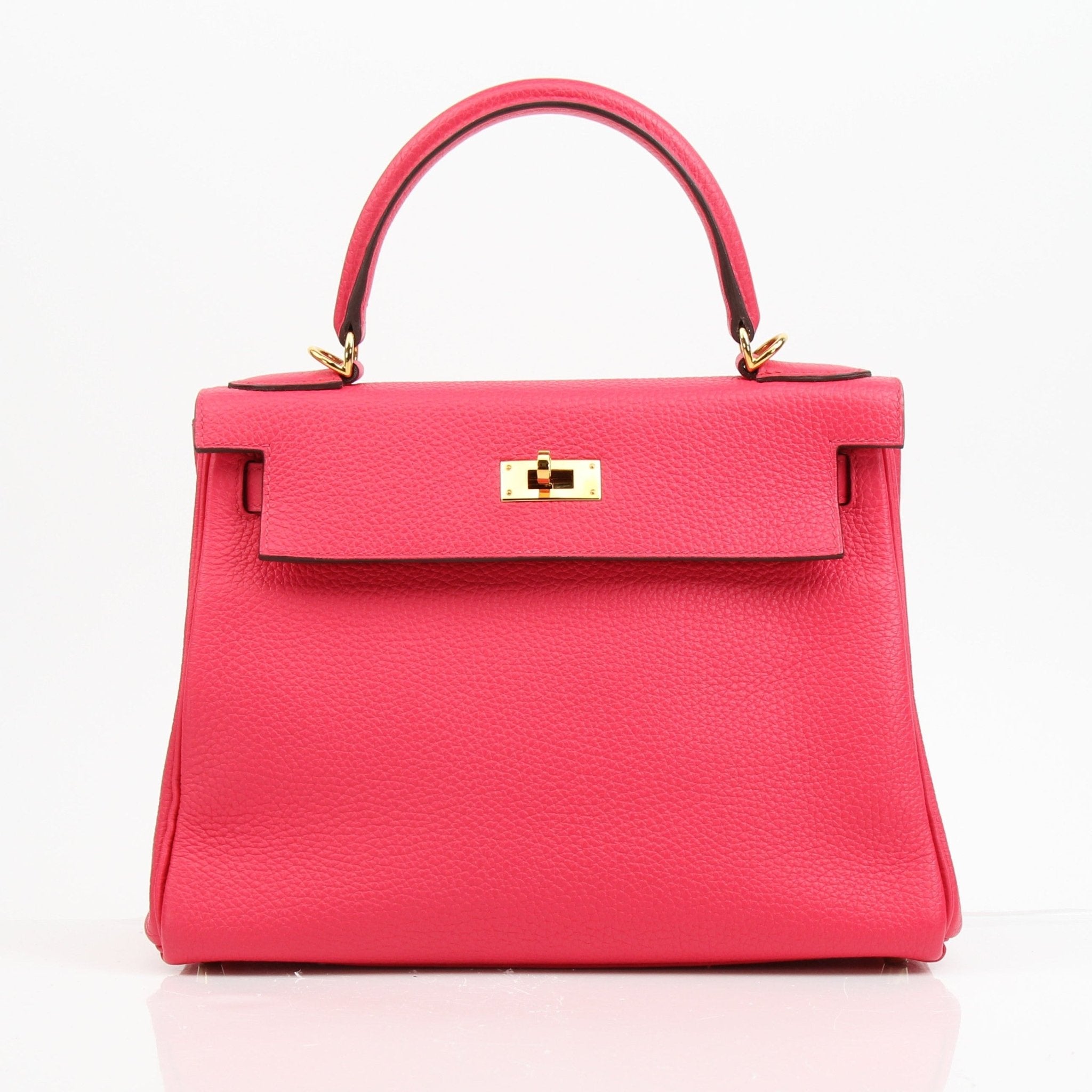 Hermès Kelly 28 pink Togo leather handbag with gold hardware, showcasing a structured design and top handle.