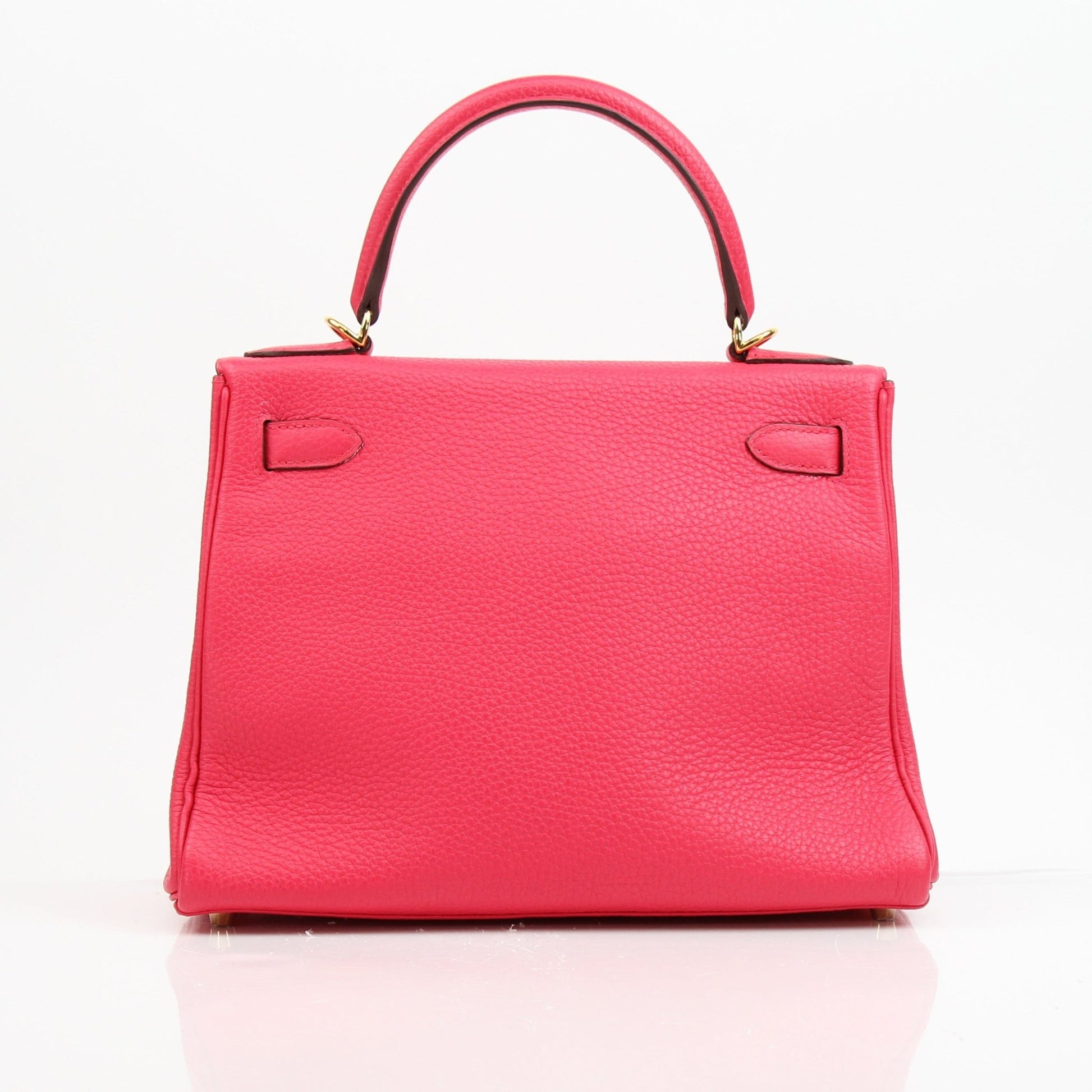 Hermès Kelly 28 pink Togo leather handbag with gold hardware, elegant and structured luxury accessory.