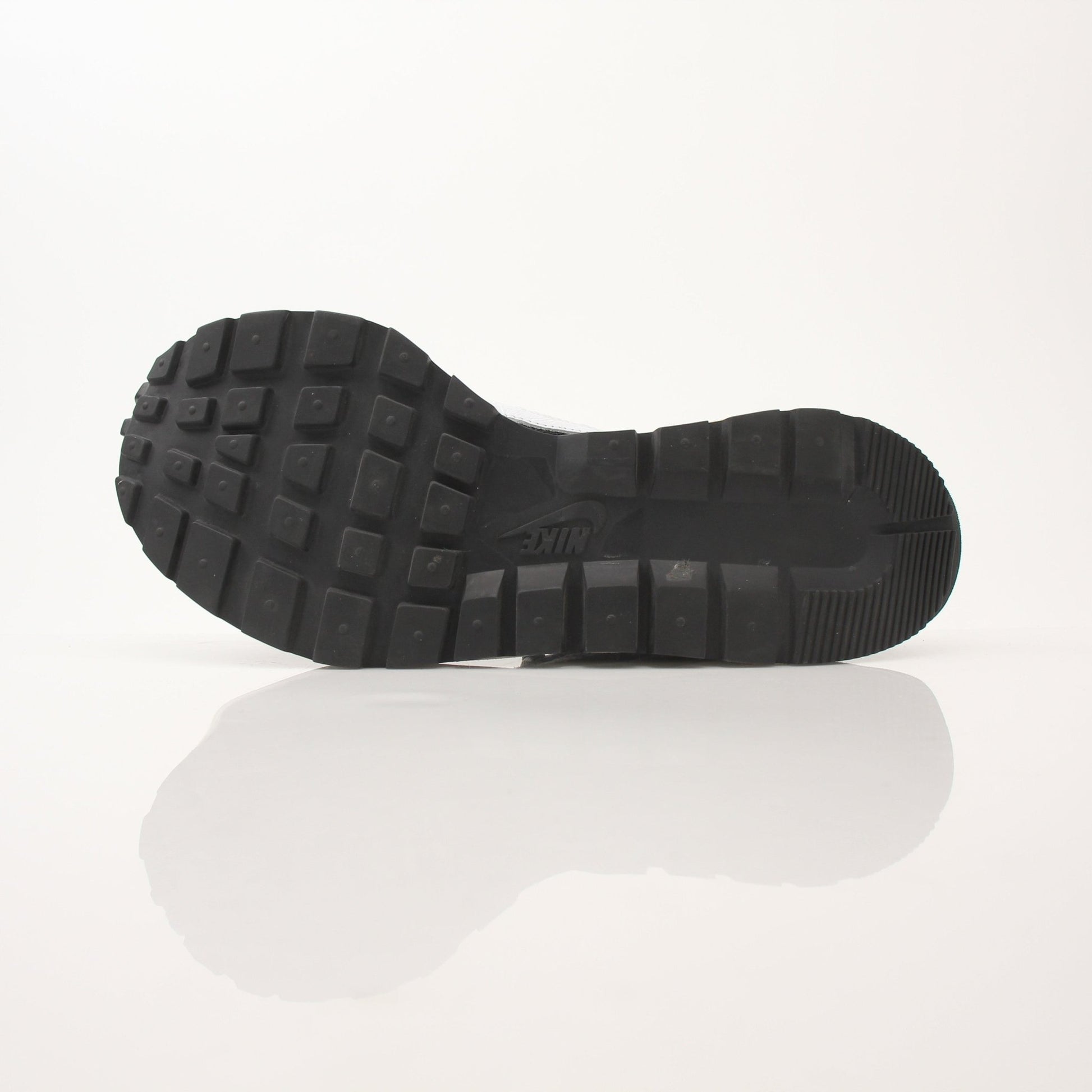 Nike x Sacai men's VaporWaffle sneakers in black and white, showcasing the layered design and textured sole.