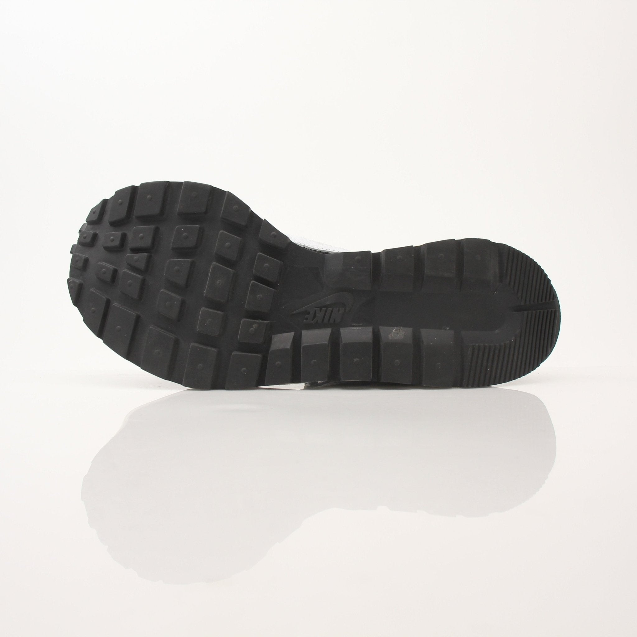 Nike x Sacai men's VaporWaffle sneakers in black and white, showcasing the layered design and textured sole.