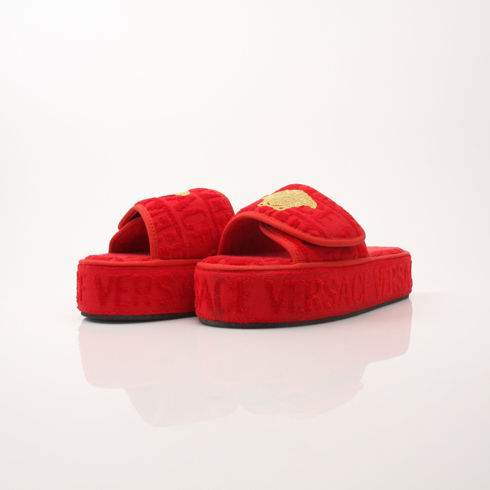 Red Versace women’s slippers with gold accents, featuring all-over design, stylish and comfortable shoes by Gold & Beyond