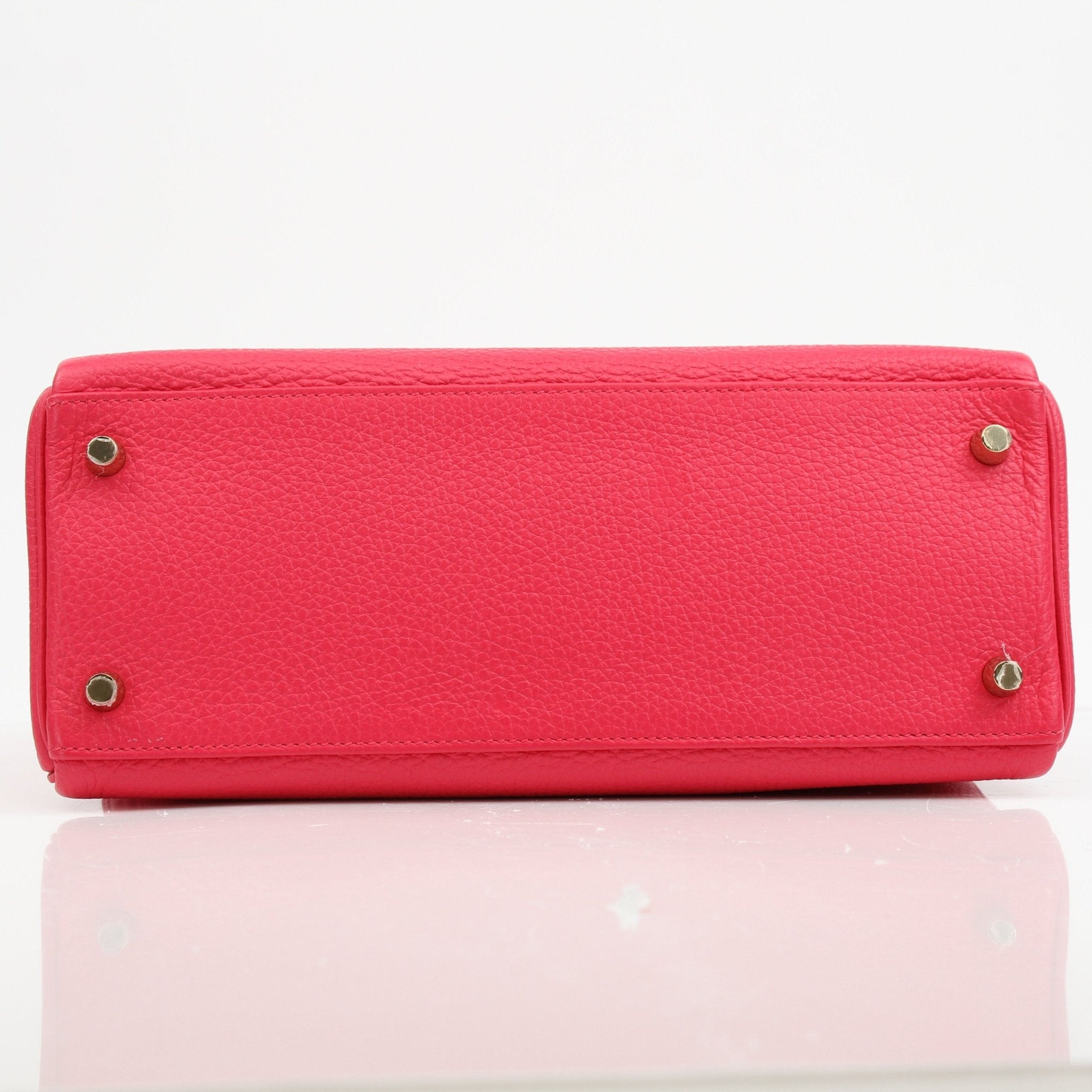 Hermès Kelly 28 pink Togo leather handbag with gold hardware, featuring structured design and top handle.