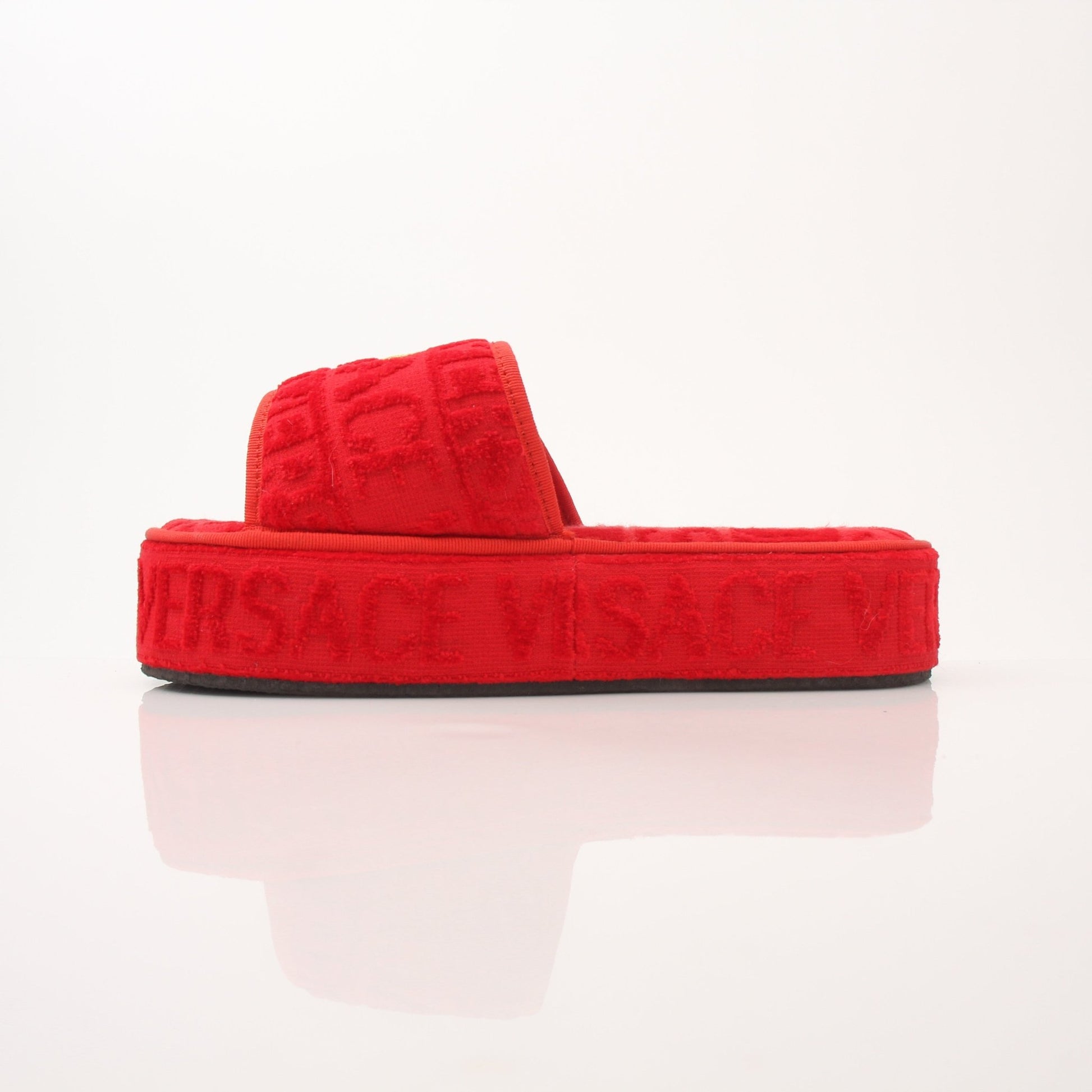 Versace women's red slippers with all-over pattern, featuring a comfortable slip-on shoe design by Gold & Beyond.