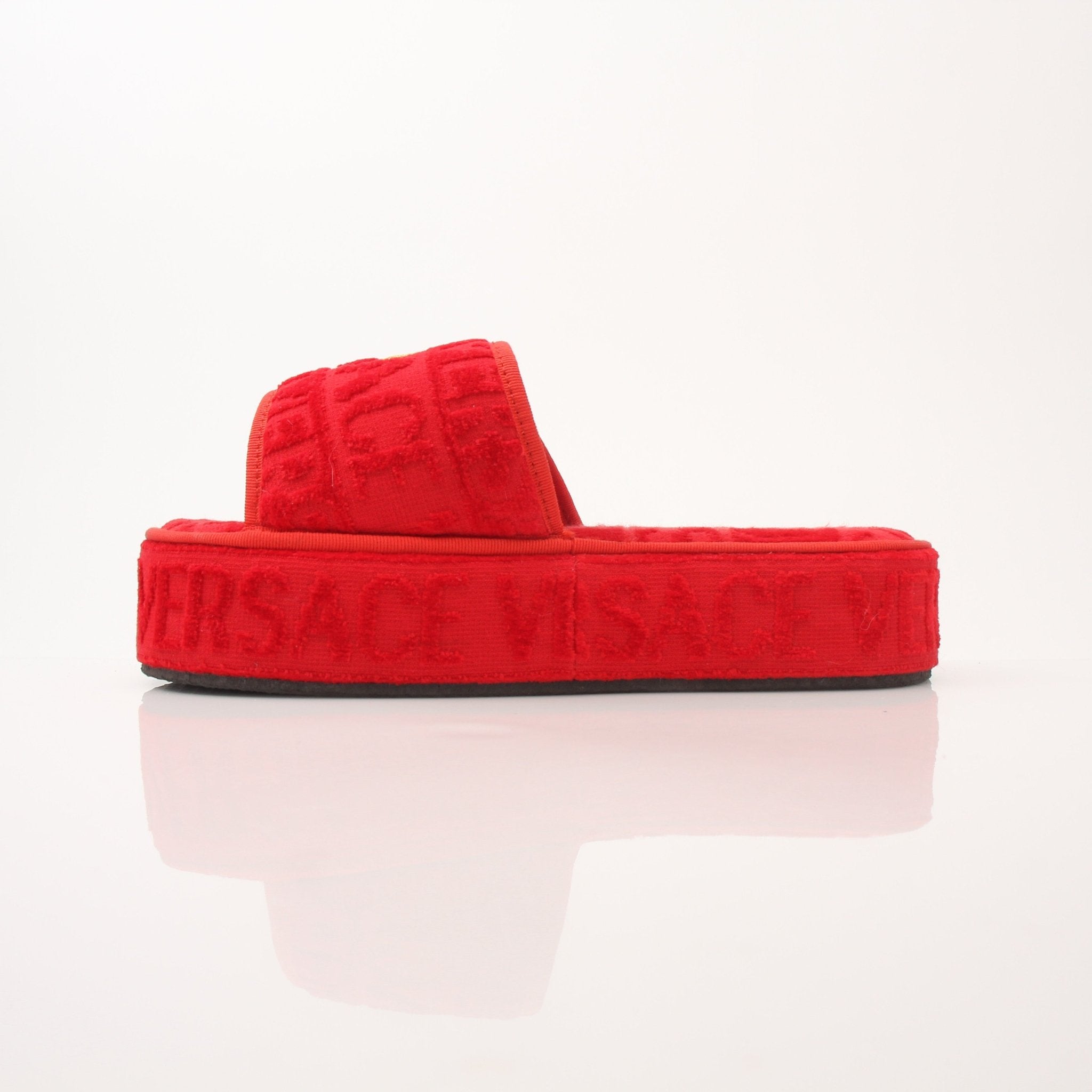 Versace women's red slippers with all-over pattern, featuring a comfortable slip-on shoe design by Gold & Beyond.