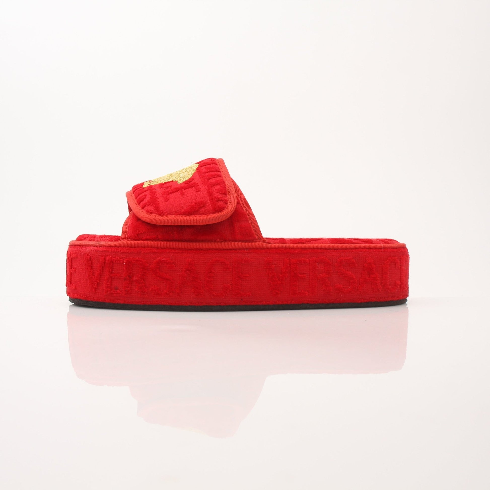 Versace women's red all-over slippers with gold accents, stylish slip-on shoes with a plush interior and decorative pattern.