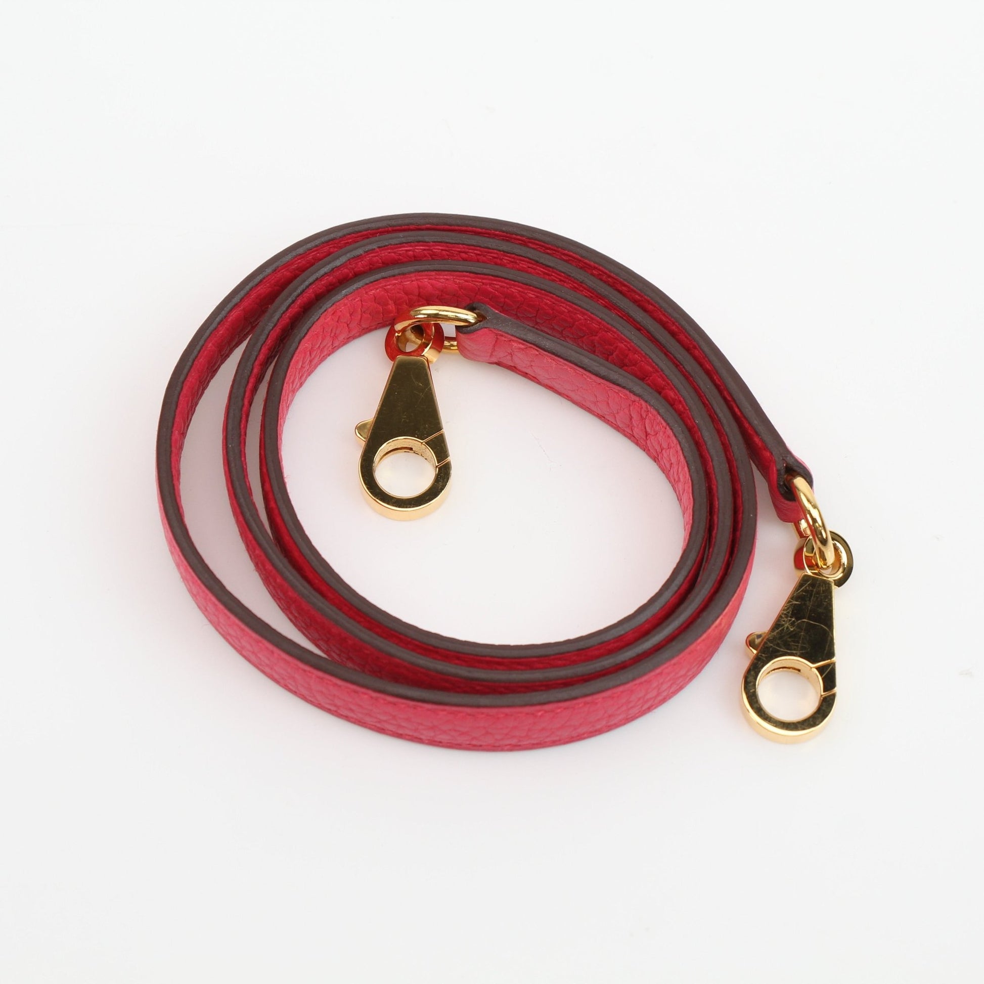 Pink Hermès Kelly 28 Togo handbag with gold hardware, featuring structured design and top handle, shown on a plain background.