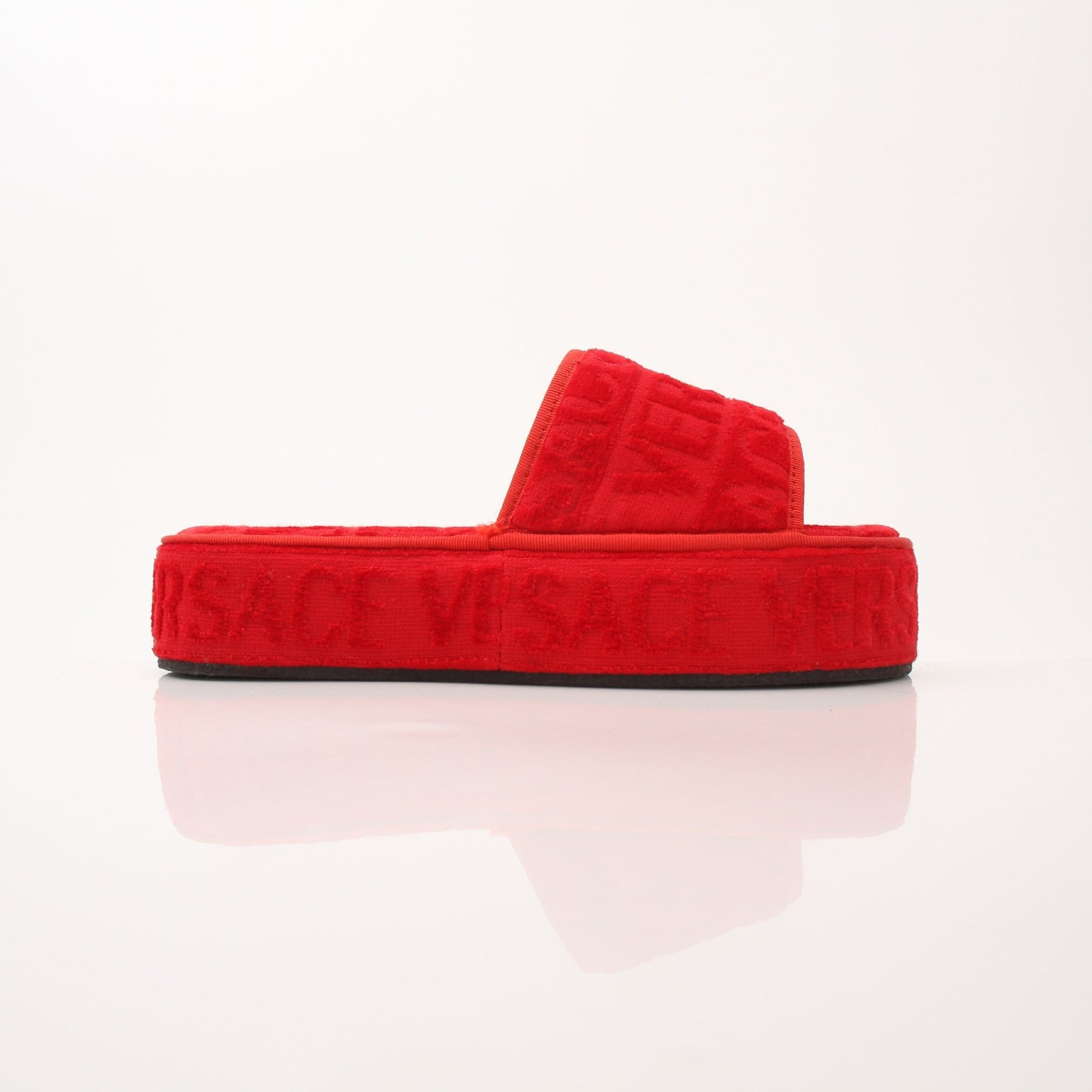 Red Versace women's slippers with gold accents, featuring all-over design and comfortable slip-on style.
