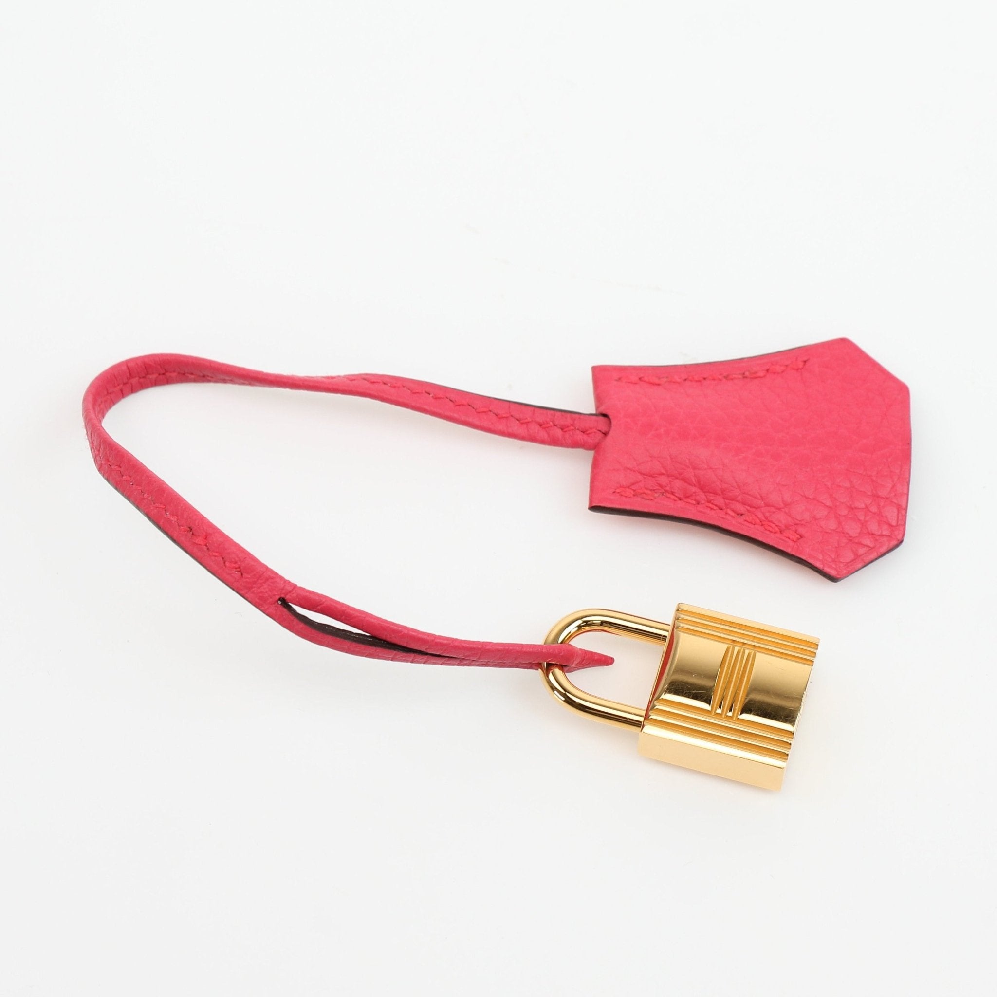 Hermès Kelly 28 pink Togo leather handbag with gold hardware, showcasing its elegant design and structured shape.