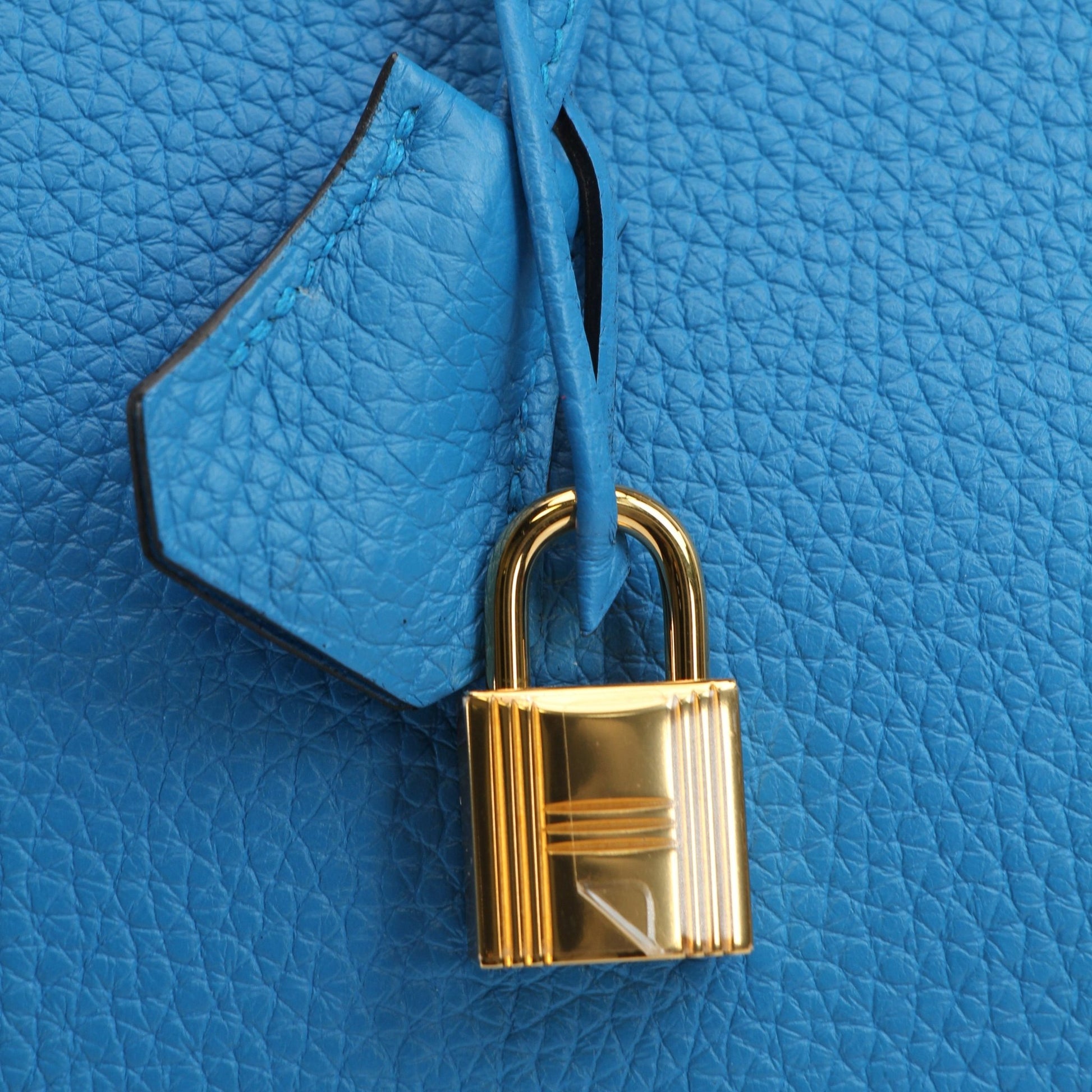 Hermès Birkin 35 Clemence handbag with gold hardware, showcasing luxurious beige leather and structured design.