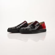 Christian Louboutin men's Pin Boat slip-on sneakers featuring sleek design and stylish detailing, displayed on a neutral background.