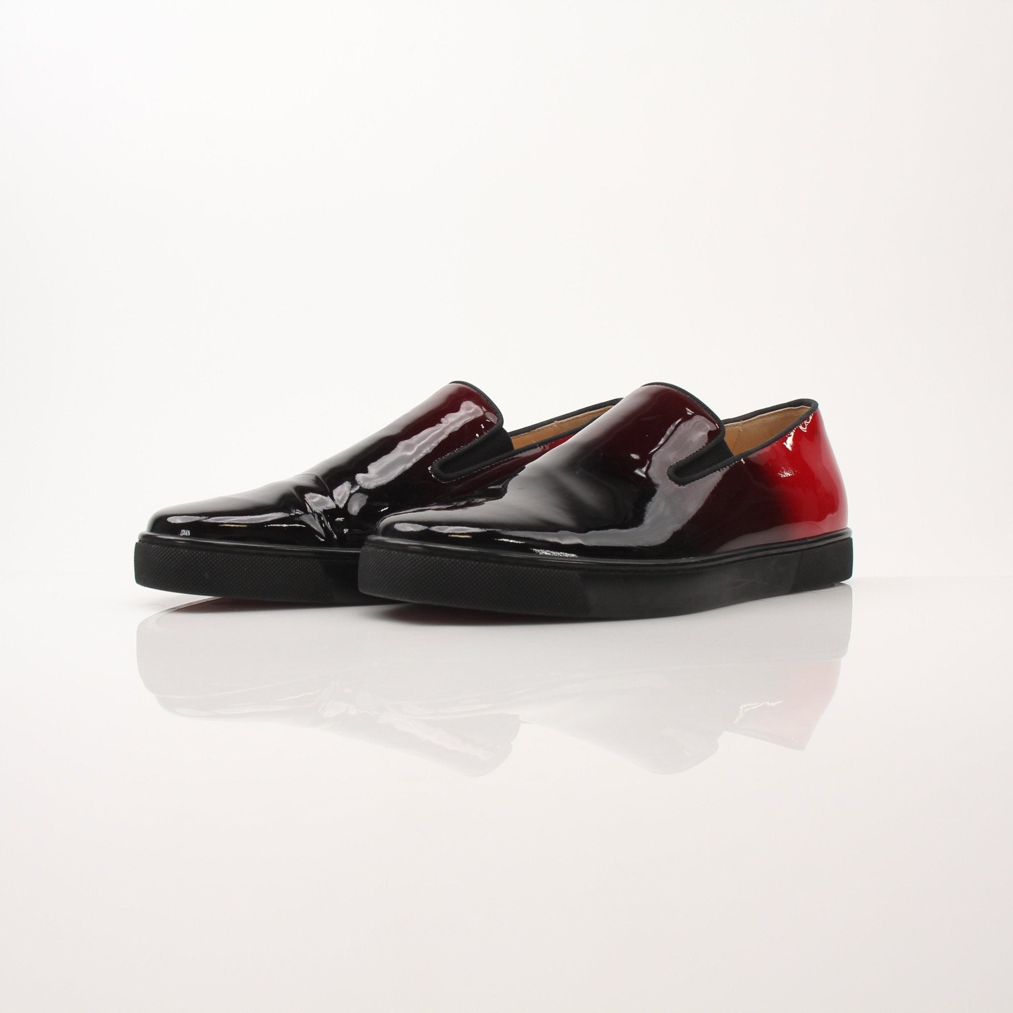Christian Louboutin men's Pin Boat slip-on sneakers featuring sleek design and stylish detailing, displayed on a neutral background.