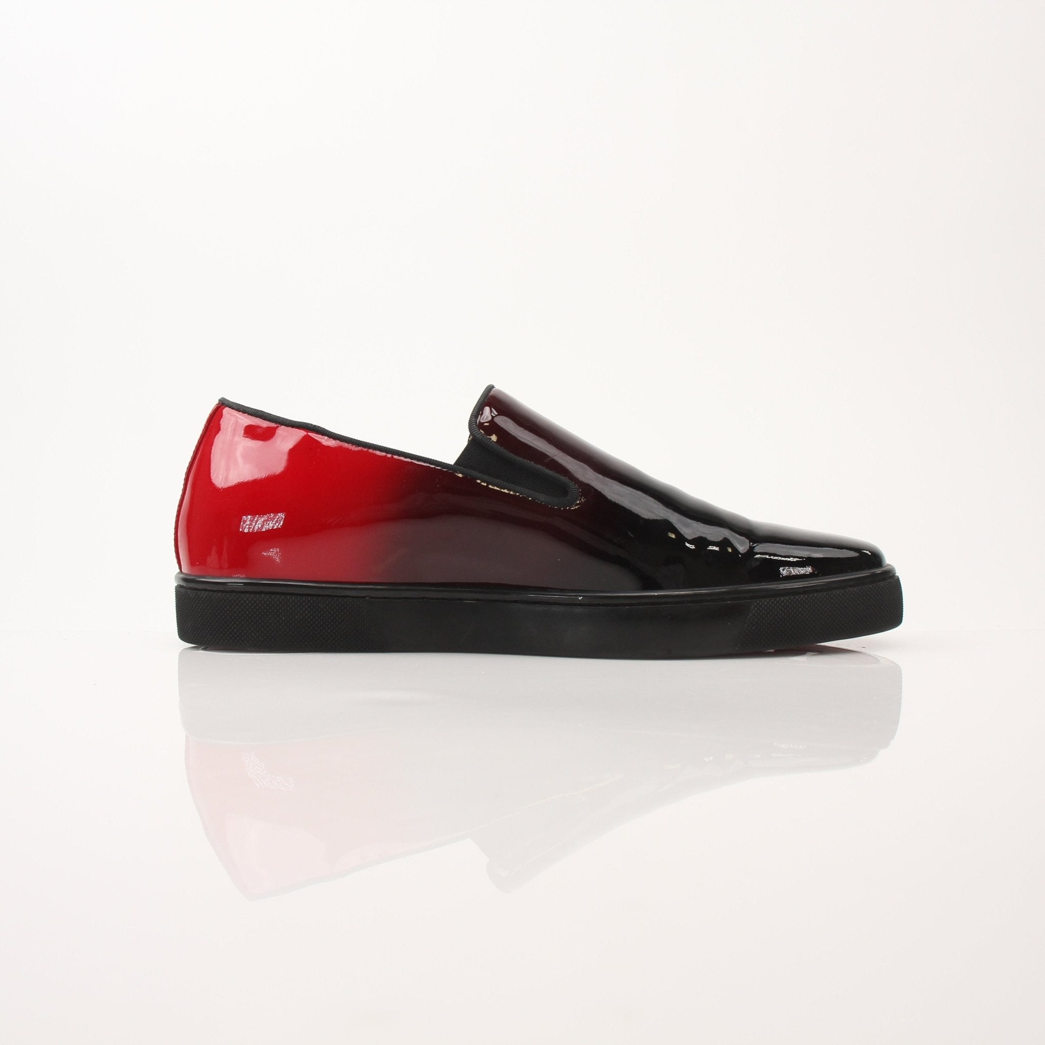 Christian Louboutin men's Pin Boat slip-on sneakers in black with signature red sole and sleek design, displayed on a plain background.