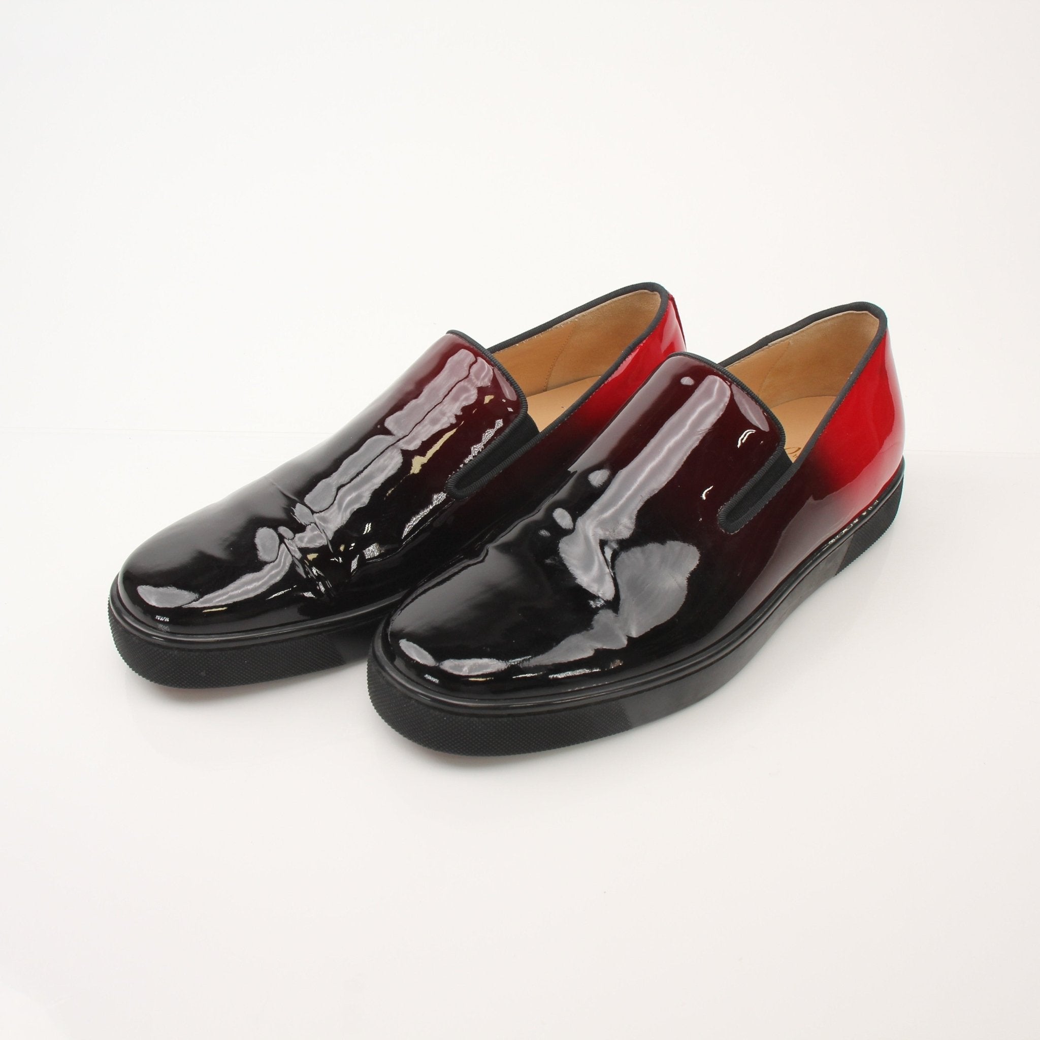 Christian Louboutin men's Pin Boat slip-on sneakers in black with signature red sole, shown on a white background.