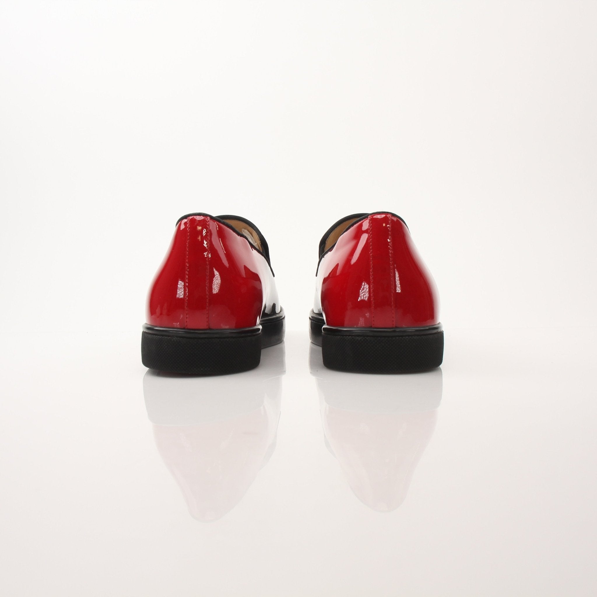 Christian Louboutin men's Pin Boat slip-on sneakers in navy blue with red soles, casual shoe style, brand logo visible.