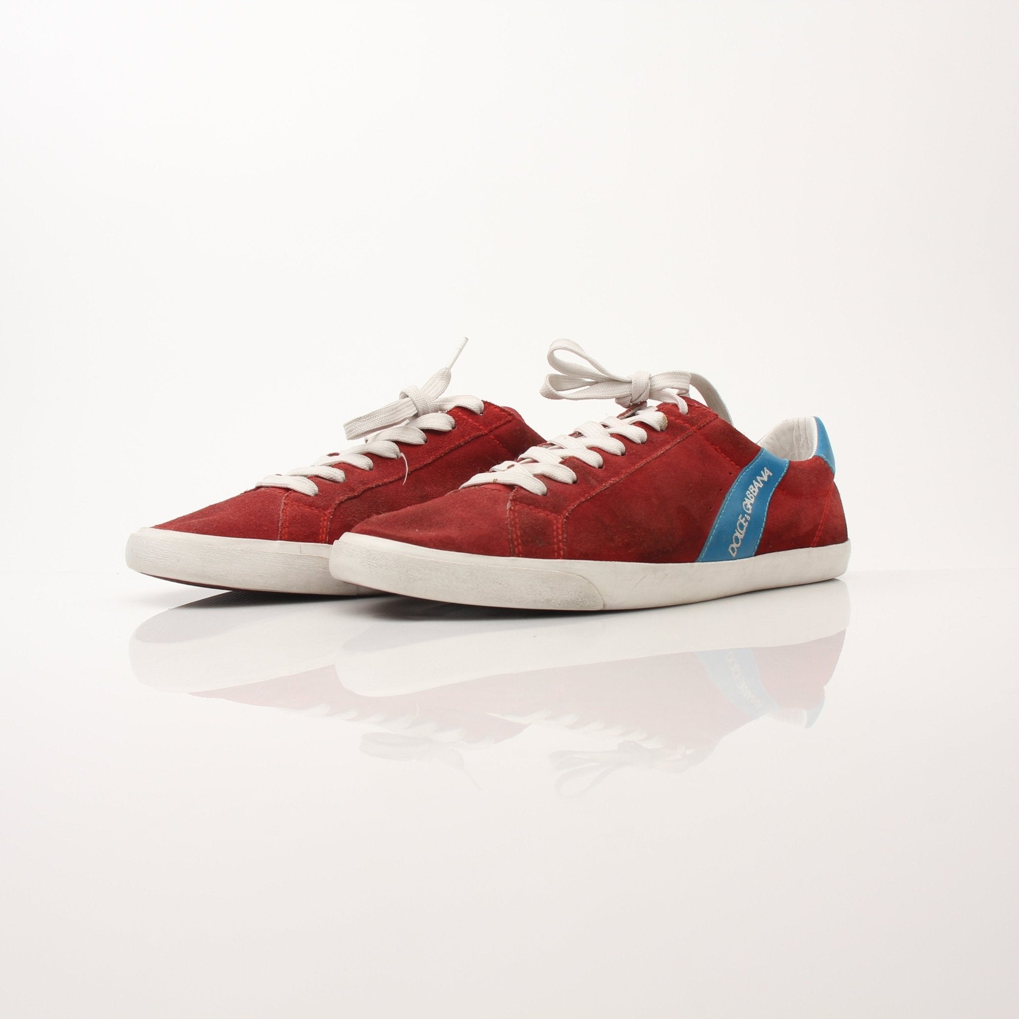 Gold & Beyond men's Dolce & Gabbana flat skating sneakers with stylish design and white soles, displayed on a plain background.