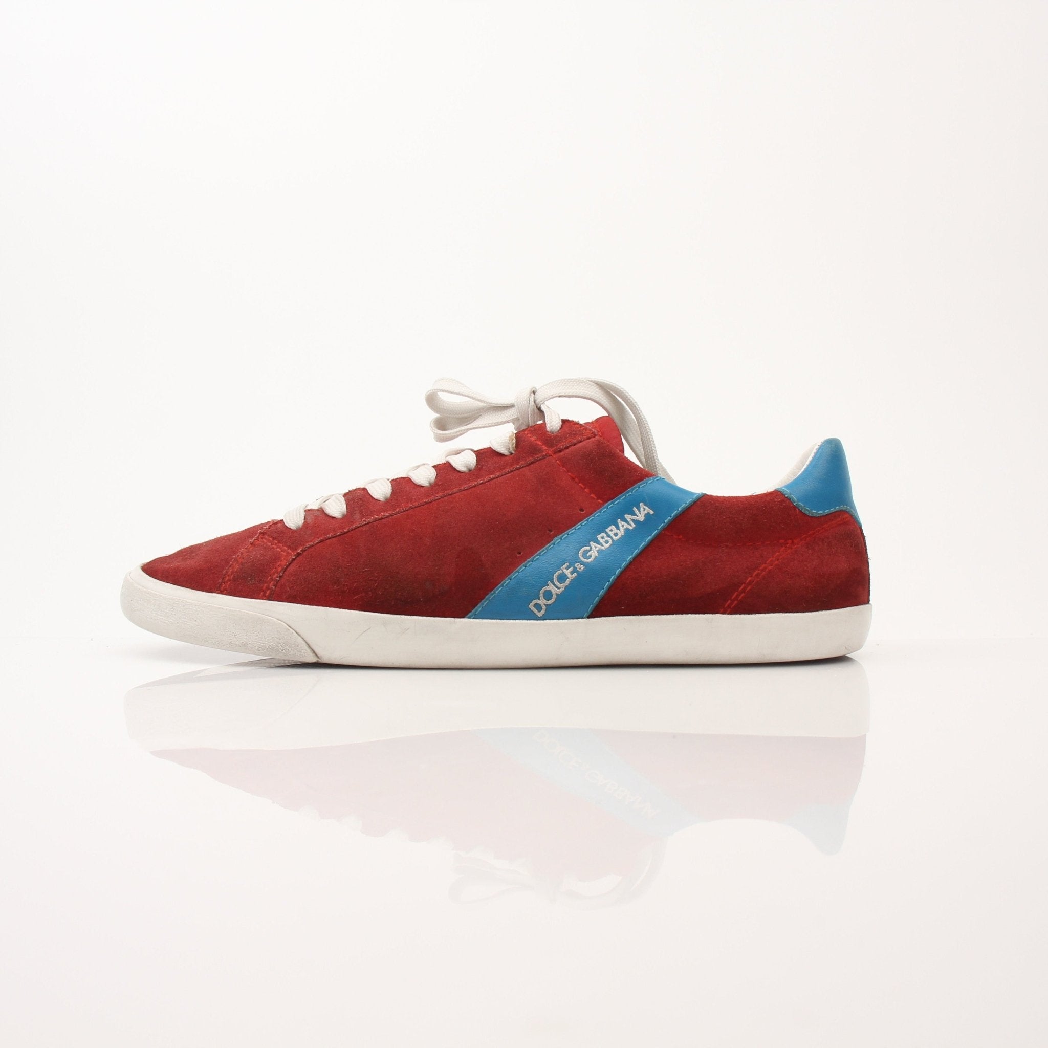Gold & Beyond men's Dolce & Gabbana flat skating sneakers with stylish design and white laces on a clean background.