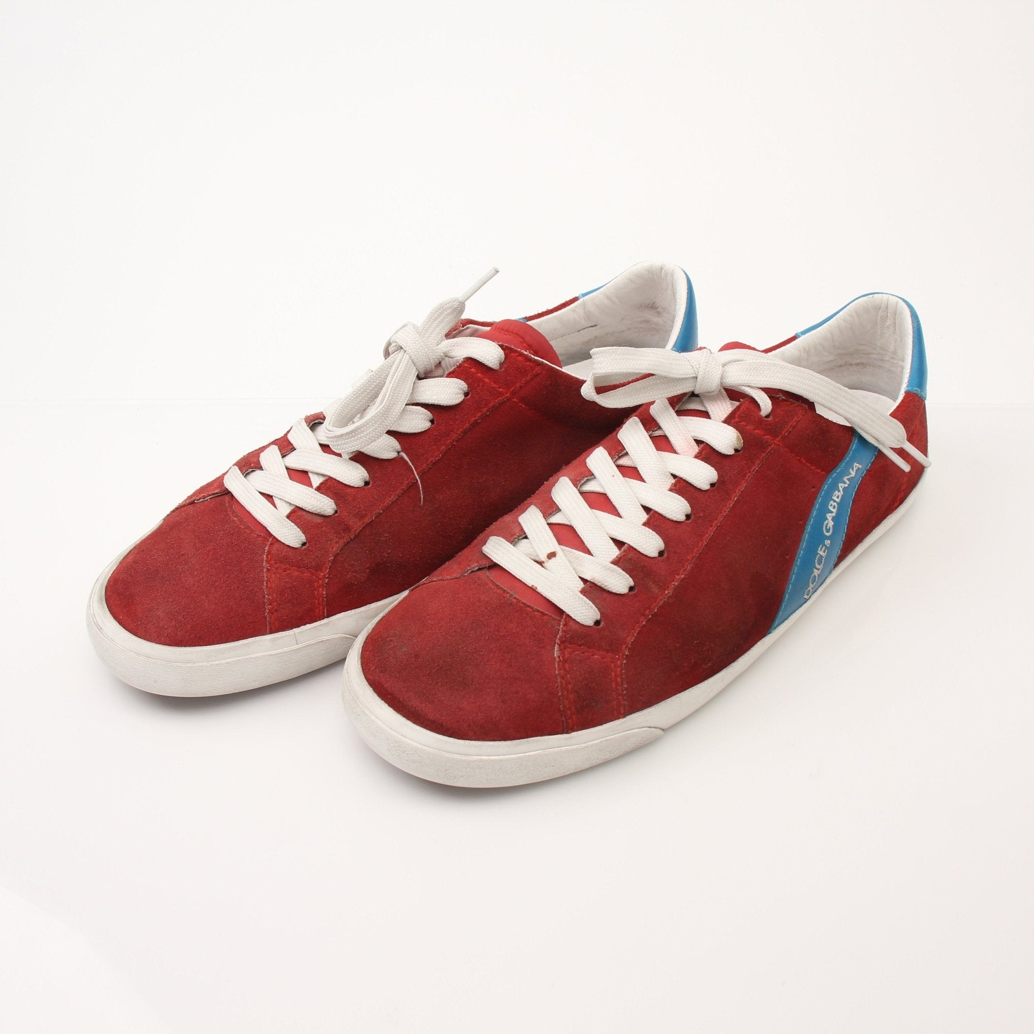 Gold & Beyond men's Dolce & Gabbana flat skating sneakers with stylish design and white laces, displayed from a side angle.
