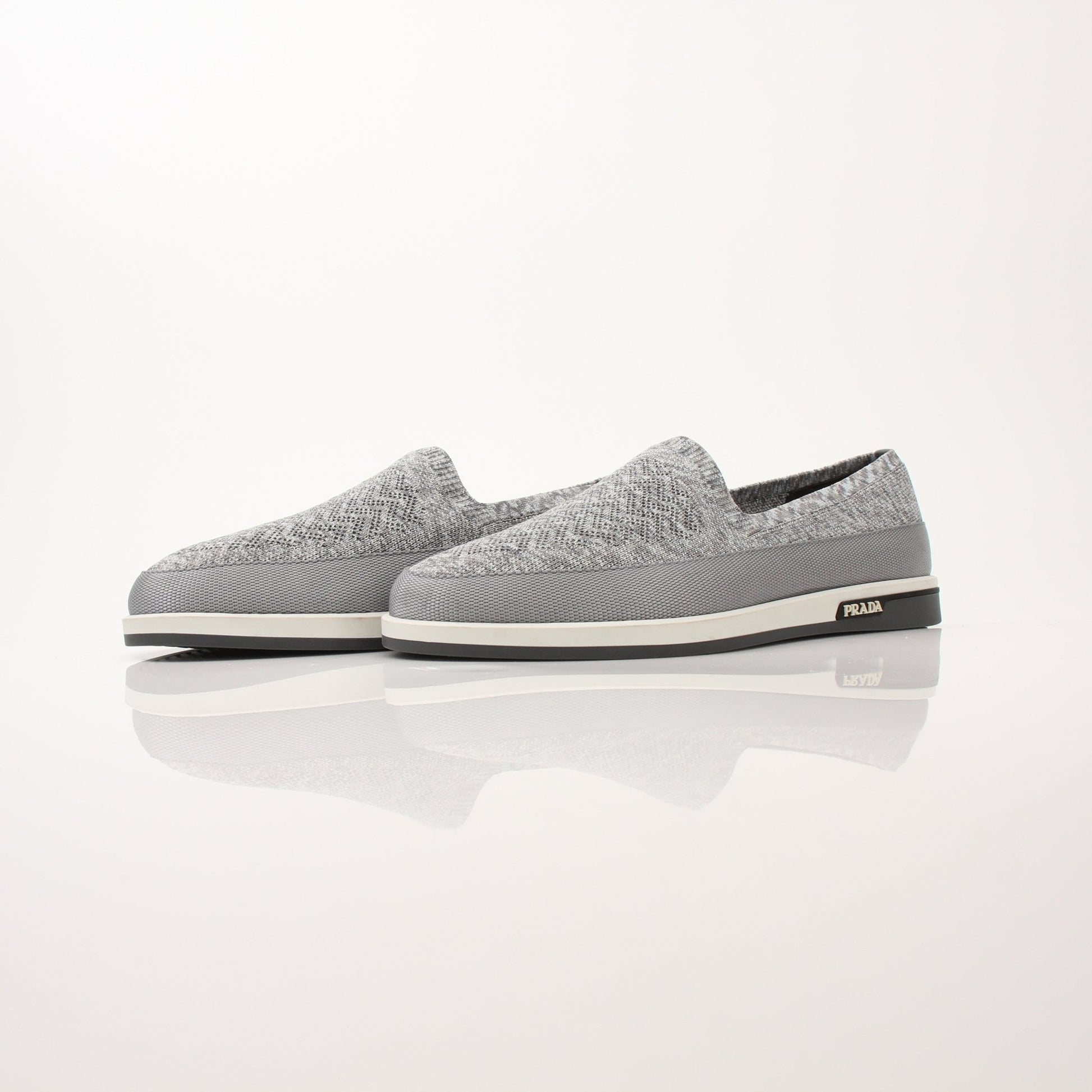 Gold & Beyond Prada Men’s Saint Tropez slip-on sneakers with sleek design and comfortable fit, shown in a close-up view.
