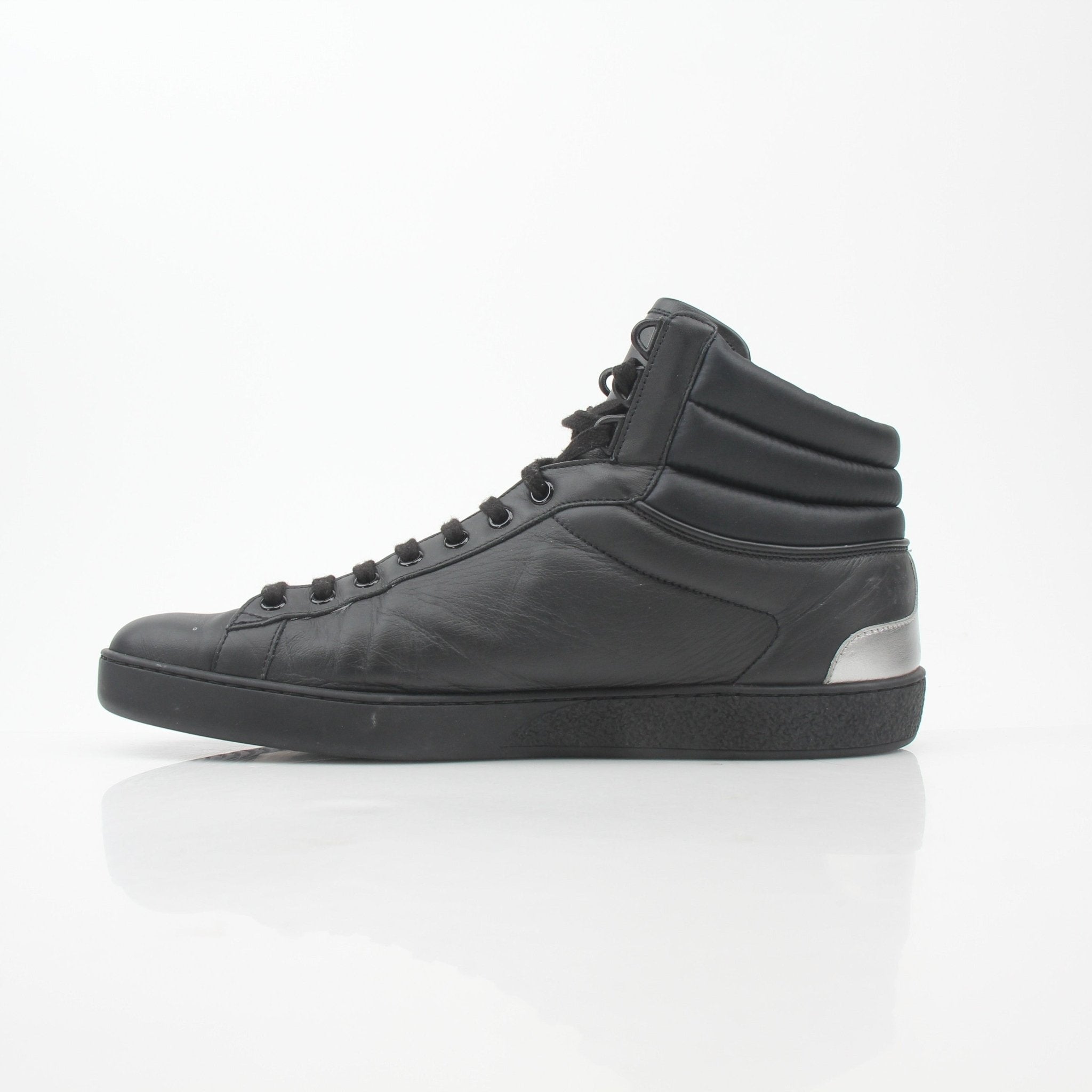 Gold & Beyond Gucci Black Ace “Gucci Band” high-top sneakers, showing the stylish design and branded details on the shoes.
