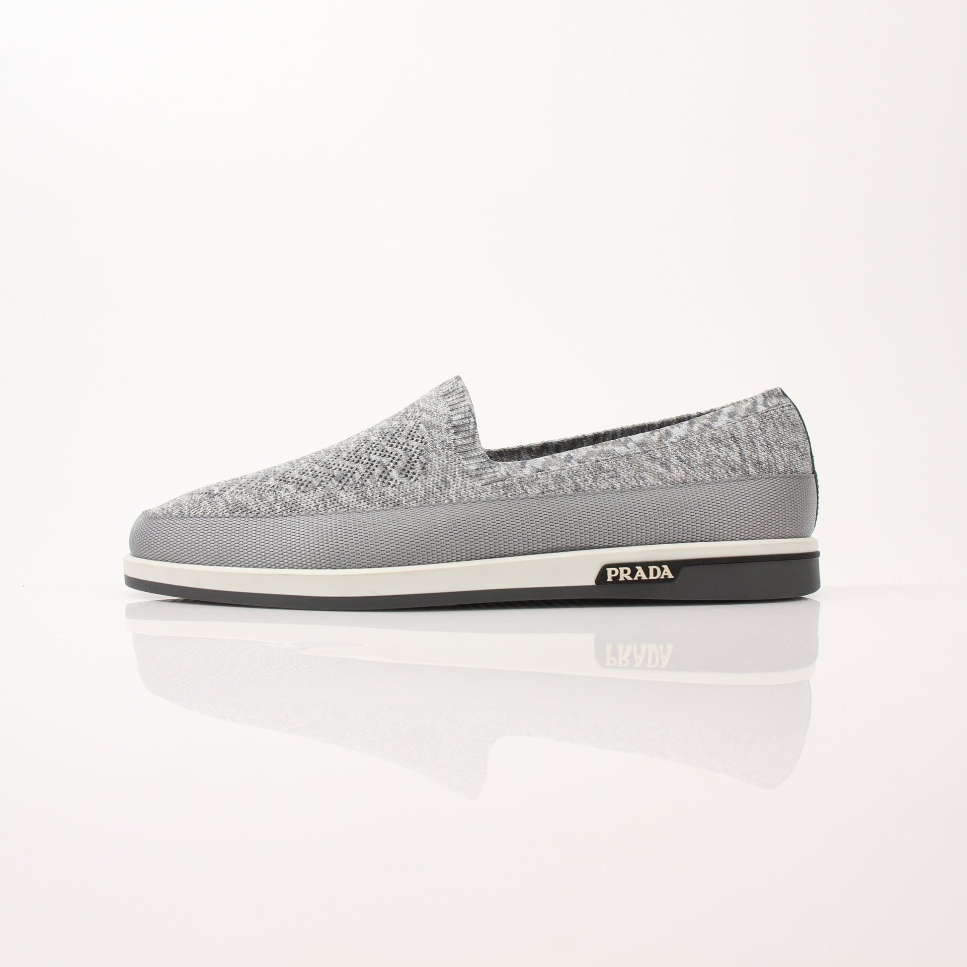Gold & Beyond Prada Men’s Saint Tropez slip-on sneakers with sleek design and casual style, shown in a close-up image.