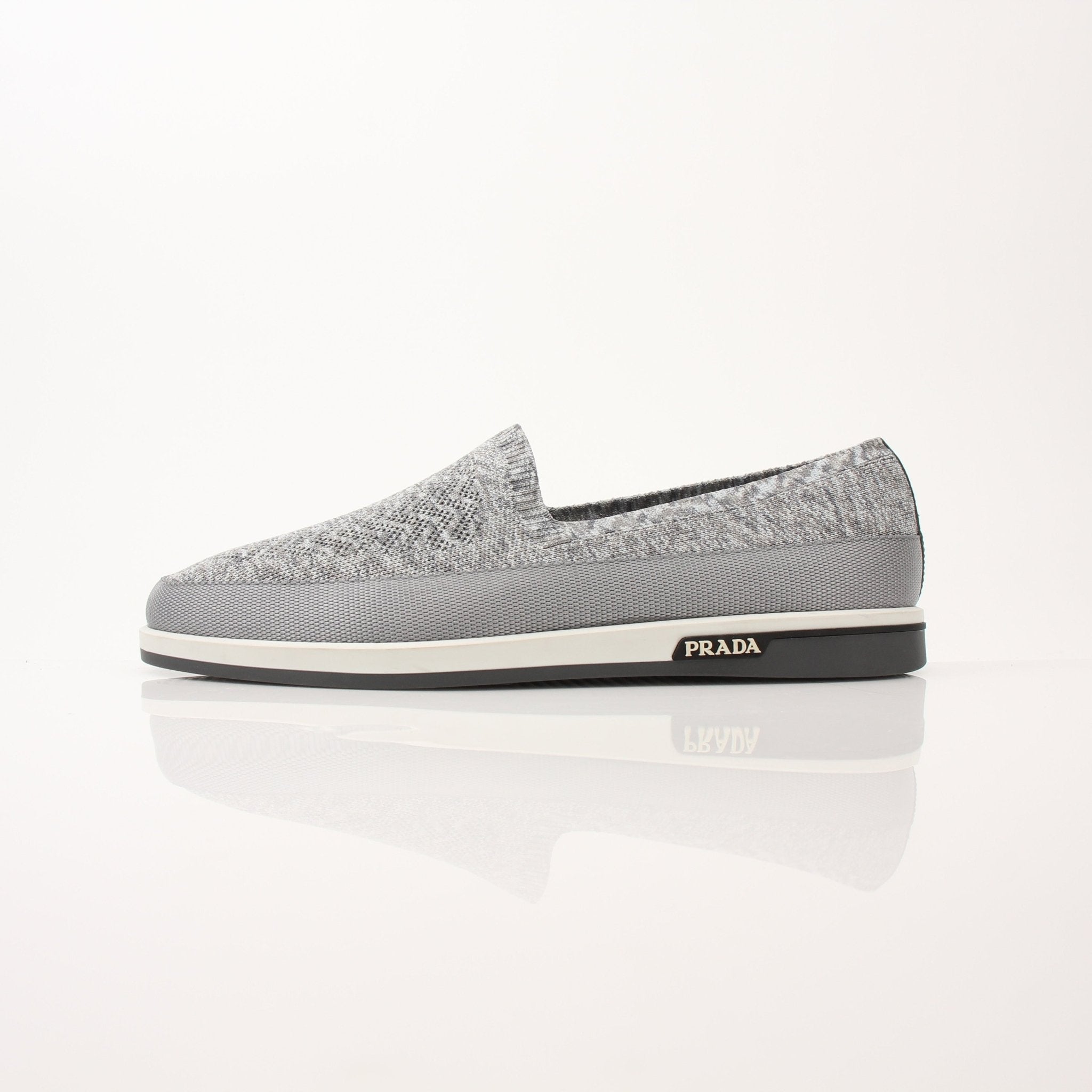 Gold & Beyond Prada Men’s Saint Tropez slip-on sneakers with sleek design and casual style, shown in a close-up image.