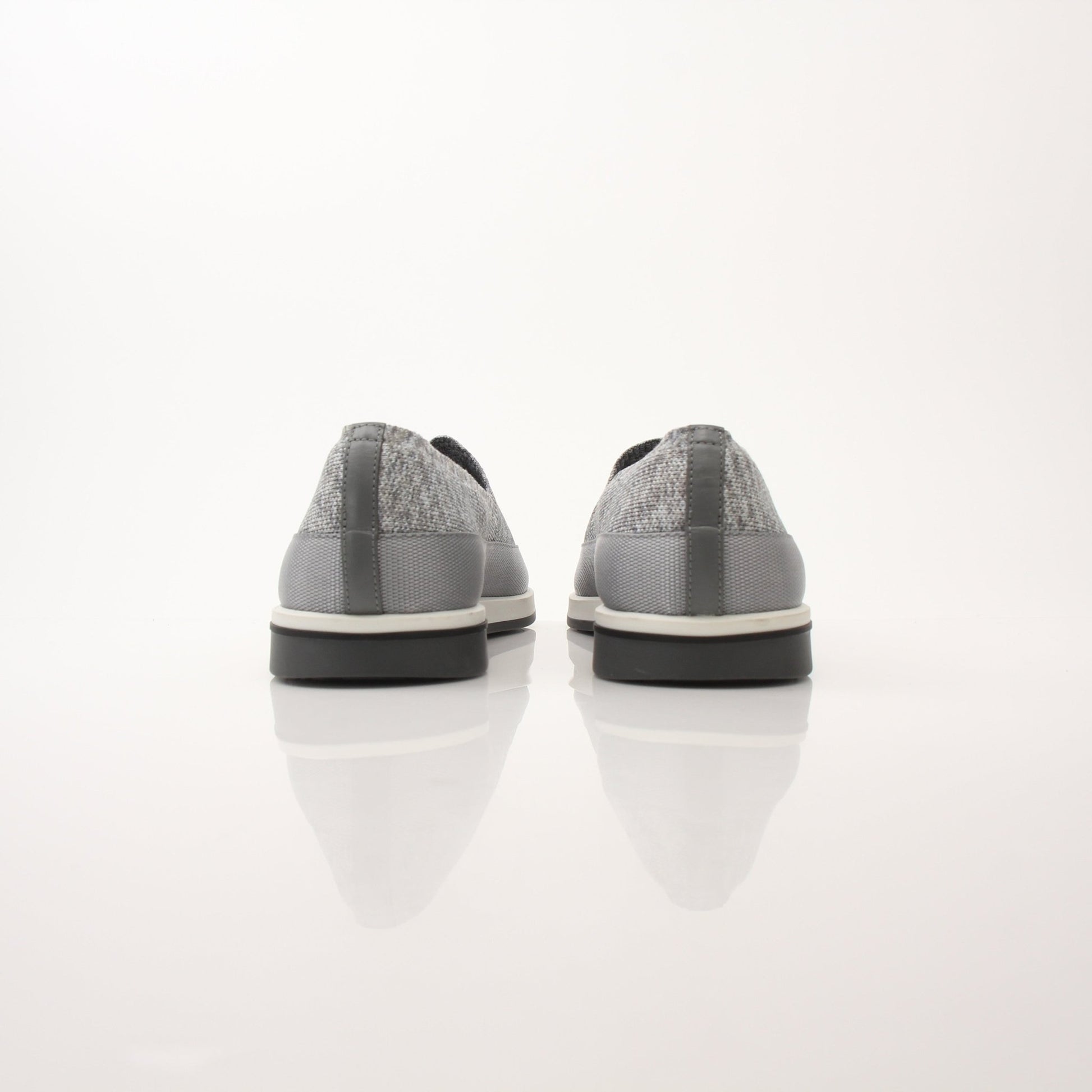 Gold & Beyond Prada Men’s Saint Tropez slip-on sneakers in black with white soles, showcasing sleek leather design and comfortable fit.
