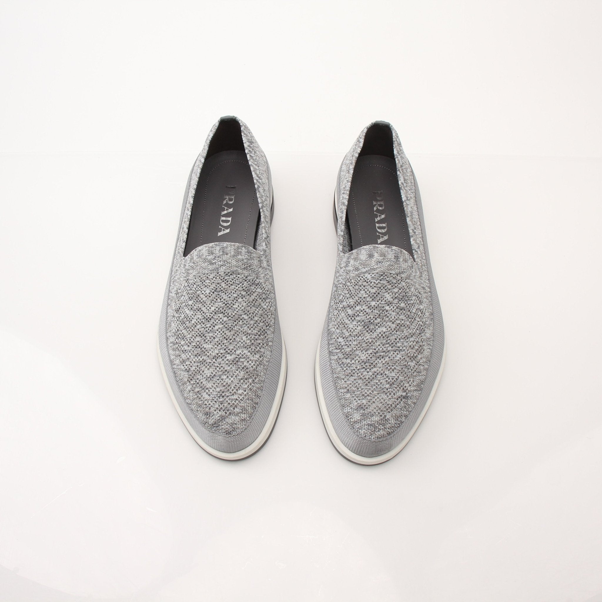 Gold & Beyond Prada Saint Tropez slip-on sneakers for men, featuring sleek design and casual footwear style.