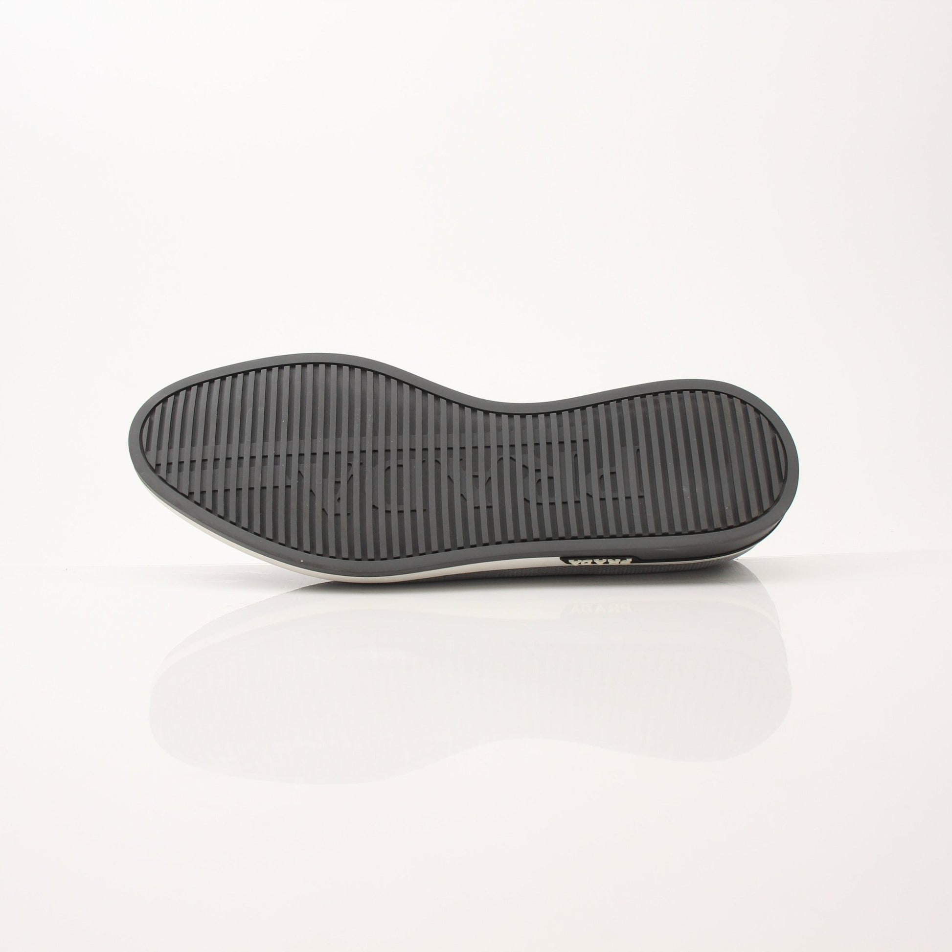 Gold & Beyond Prada Men’s Saint Tropez slip-on sneakers, stylish shoes with sleek design and comfortable fit, shown on a white background.