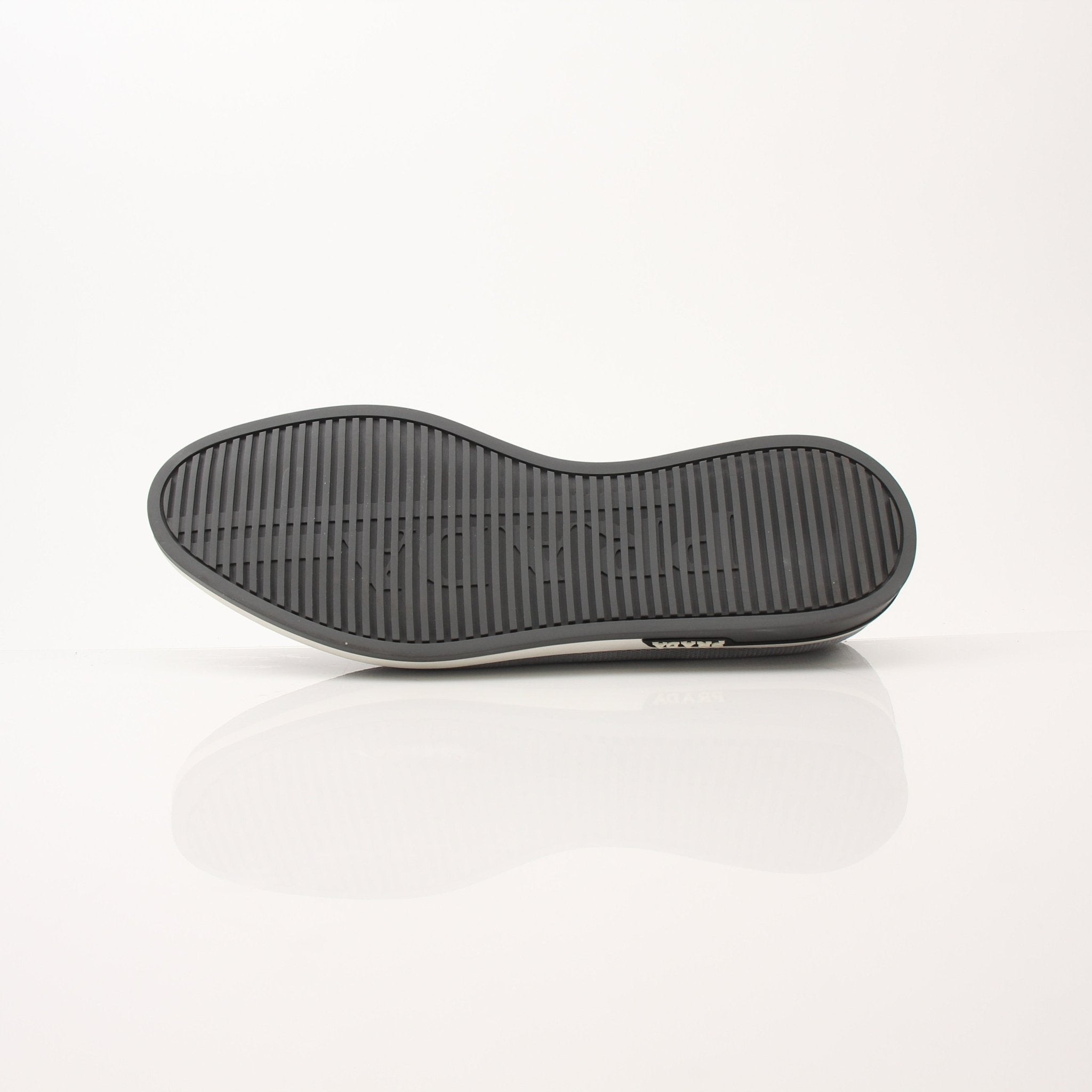 Gold & Beyond Prada Men’s Saint Tropez slip-on sneakers, stylish shoes with sleek design and comfortable fit, shown on a white background.