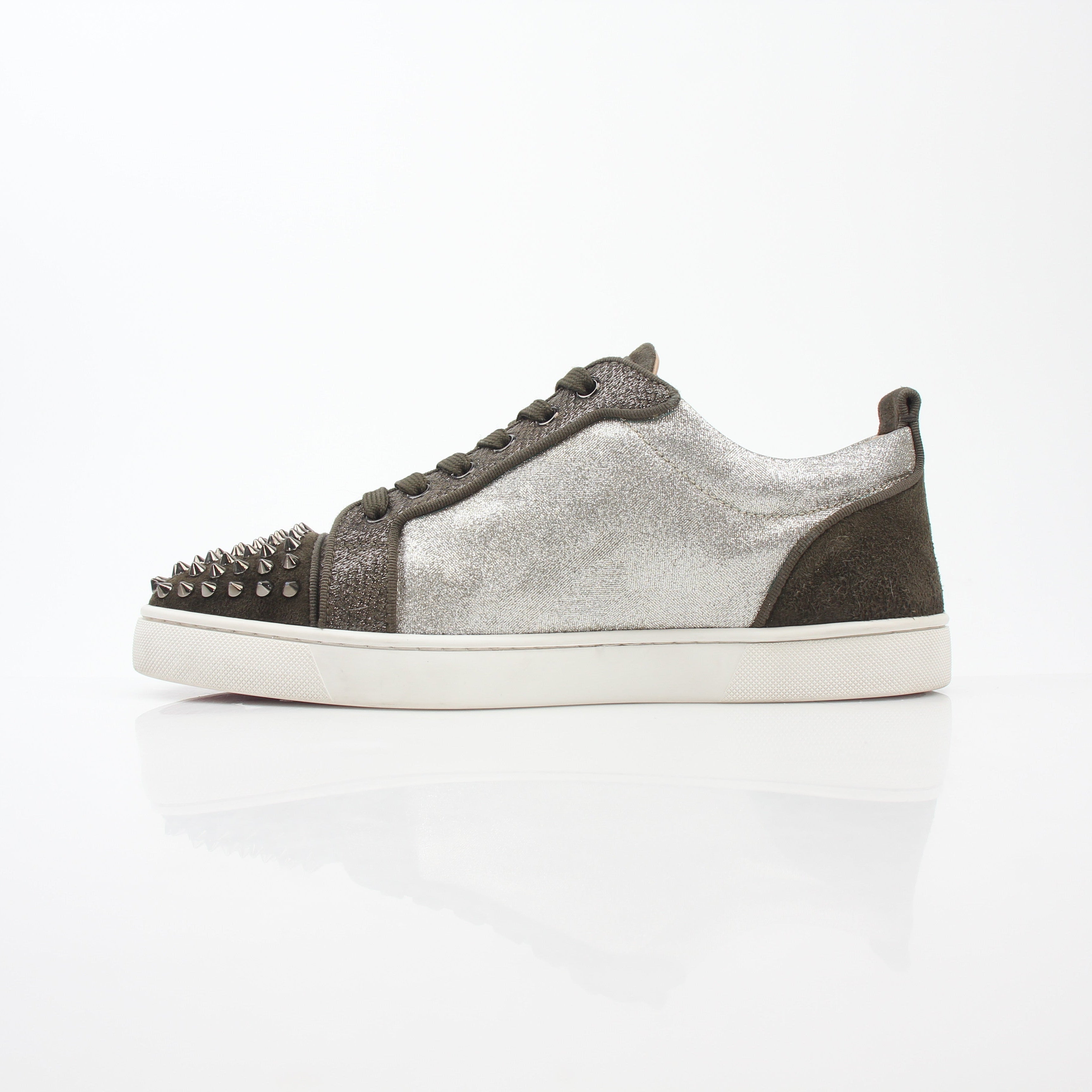 Christian Louboutin Silver Louis Junior Spikes Orlato sneakers with spike details and sleek design, displayed on a white background.